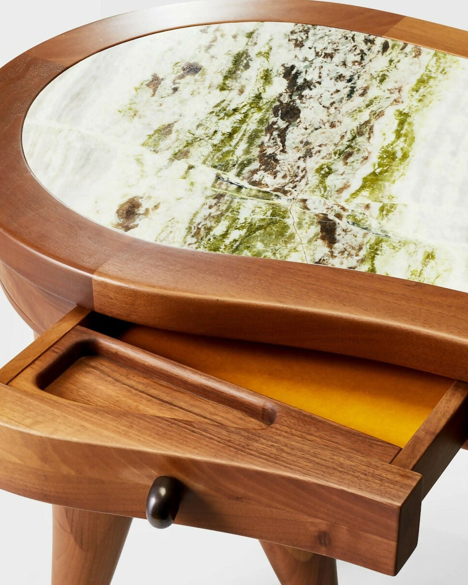A wooden desk with a curved, organic shape and solid wood legs, featuring a marble top with brass hardware and leather inlay drawers,  available  to buy on the-salon.com. SALON curates the finest , unique, handmade pieces from the interior industry's best makers and brands. Shop luxury furniture, lighting, rugs, art, antiques and vintage pieces and accessories from SALON interior designed rooms.