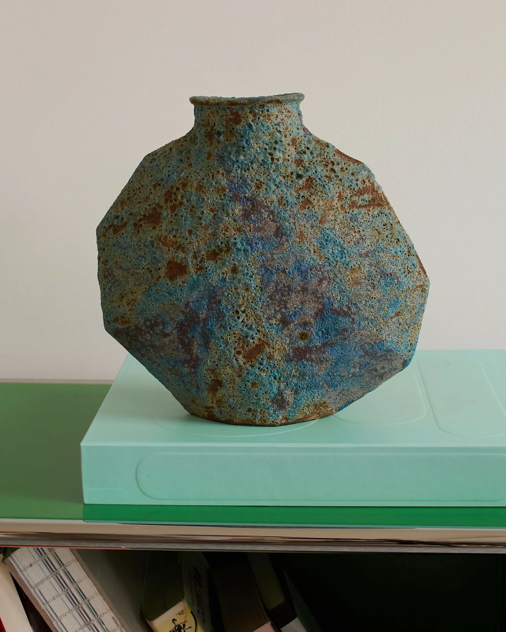 A ceramic vase with an angular form and a vibrant textural glaze in turquoise, blue, and subtle green tones,  available  to buy on the-salon.com. SALON curates the finest , unique, handmade pieces from the interior industry's best makers and brands. Shop luxury furniture, lighting, rugs, art, antiques and vintage pieces and accessories from SALON interior designed rooms.