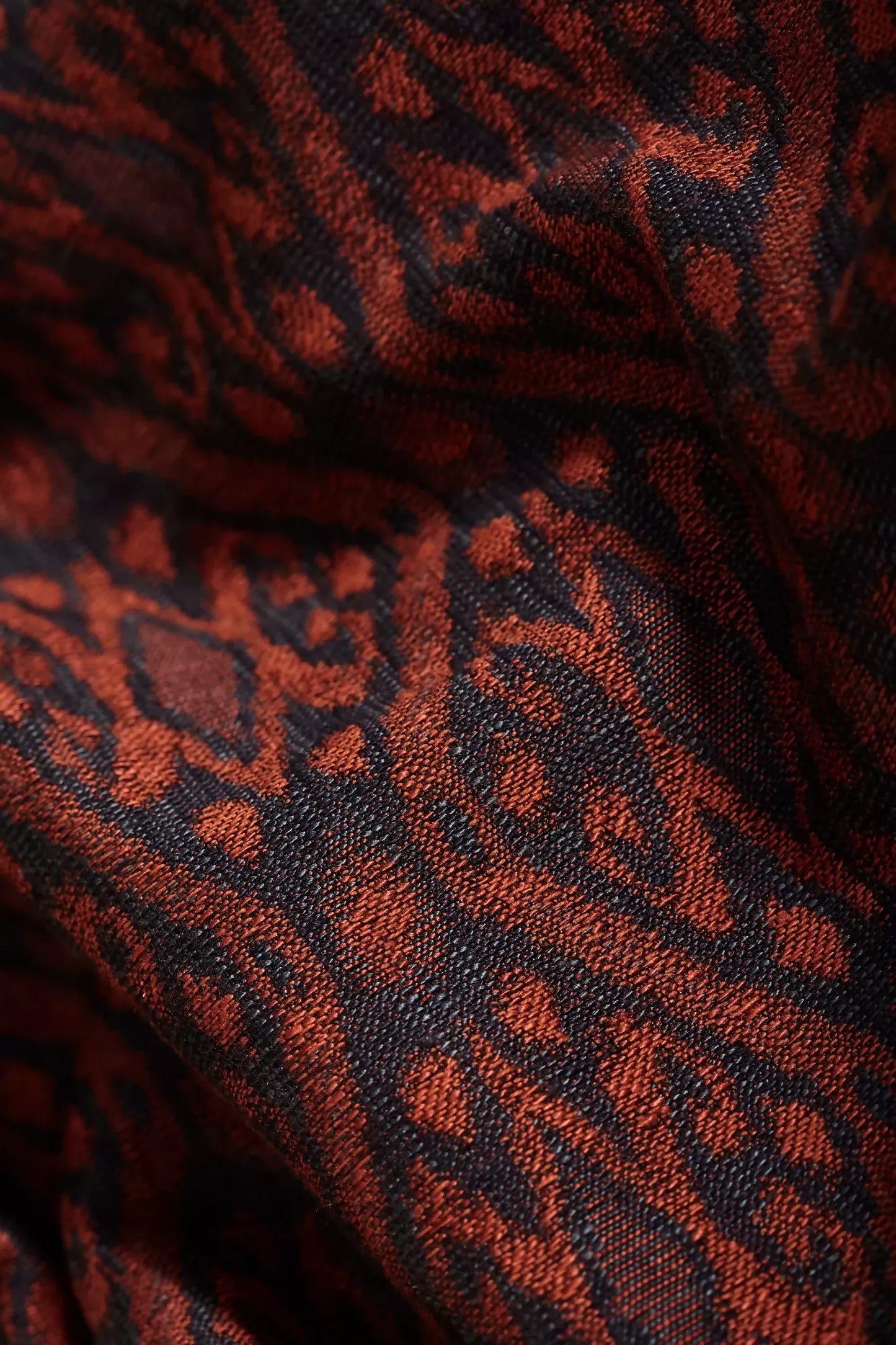 A fabric with a woven ikat pattern, featuring a geometric design in a jasper colour,  available  to buy on the-salon.com. SALON curates the finest , unique, handmade pieces from the interior industry's best makers and brands. Shop luxury furniture, lighting, rugs, art, antiques and vintage pieces and accessories from SALON interior designed rooms.