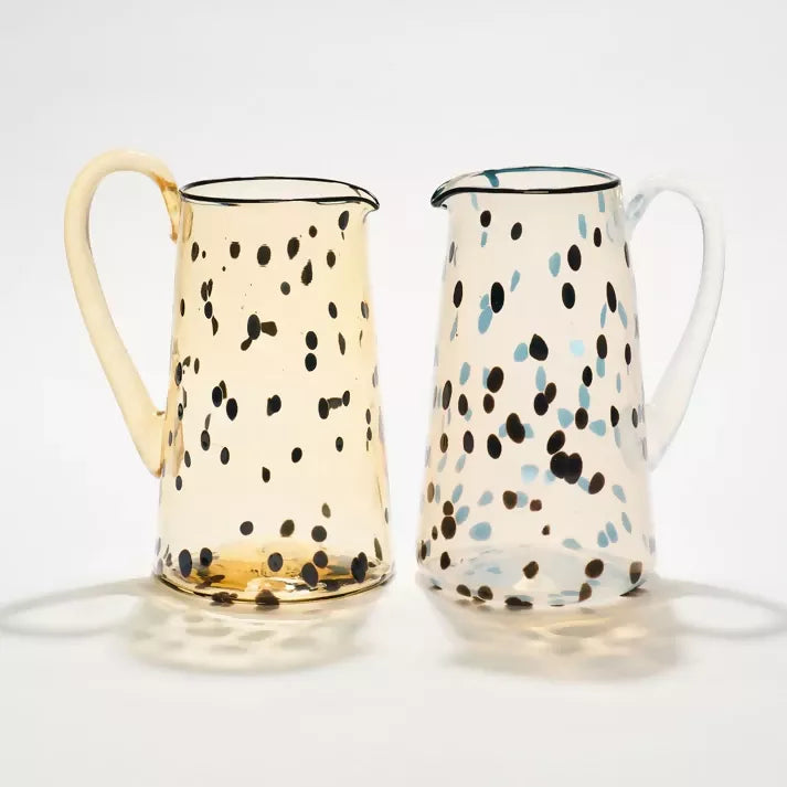 Two glass jugs with polka dots,  available  to buy on the-salon.com. SALON curates the finest , unique, handmade pieces from the interior industry's best makers and brands. Shop luxury furniture, lighting, rugs, art, antiques and vintage pieces and accessories from SALON interior designed rooms.