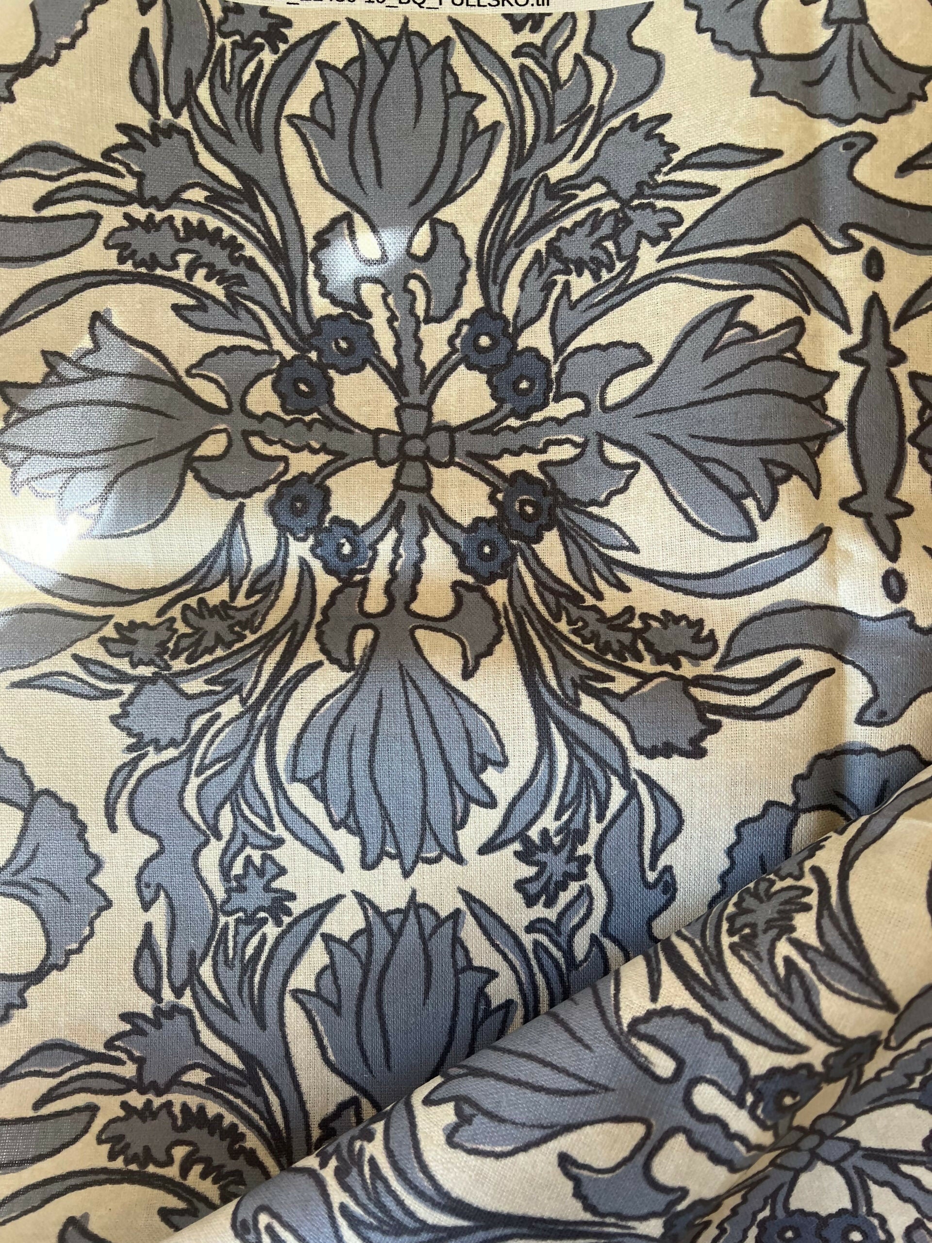 A close-up view of a vintage scarf fabric featuring a detailed and ornate floral pattern in shades of black and gray on a beige background,  available  to buy on the-salon.com. SALON curates the finest , unique, handmade pieces from the interior industry's best makers and brands. Shop luxury furniture, lighting, rugs, art, antiques and vintage pieces and accessories from SALON interior designed rooms.