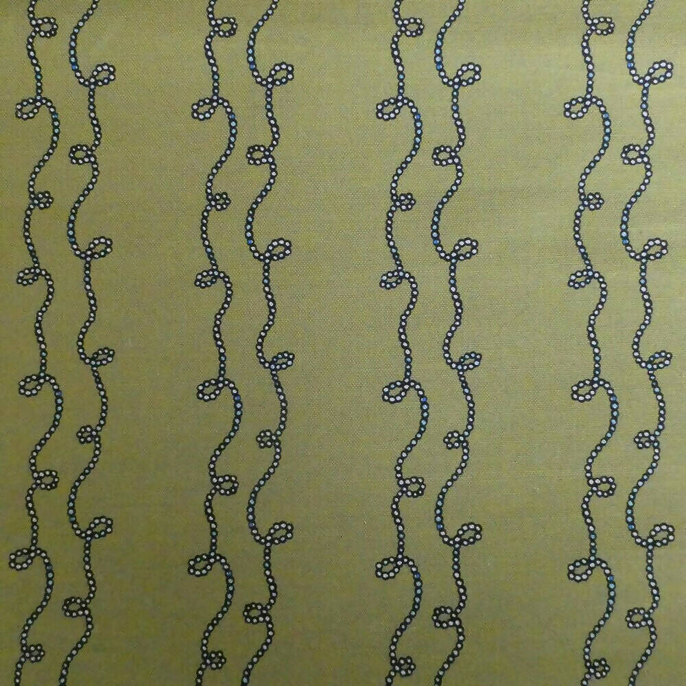 A swatch of fabric featuring a yellow background with a blue geometric pattern consisting of twisted shapes,  available  to buy on the-salon.com. SALON curates the finest , unique, handmade pieces from the interior industry's best makers and brands. Shop luxury furniture, lighting, rugs, art, antiques and vintage pieces and accessories from SALON interior designed rooms.