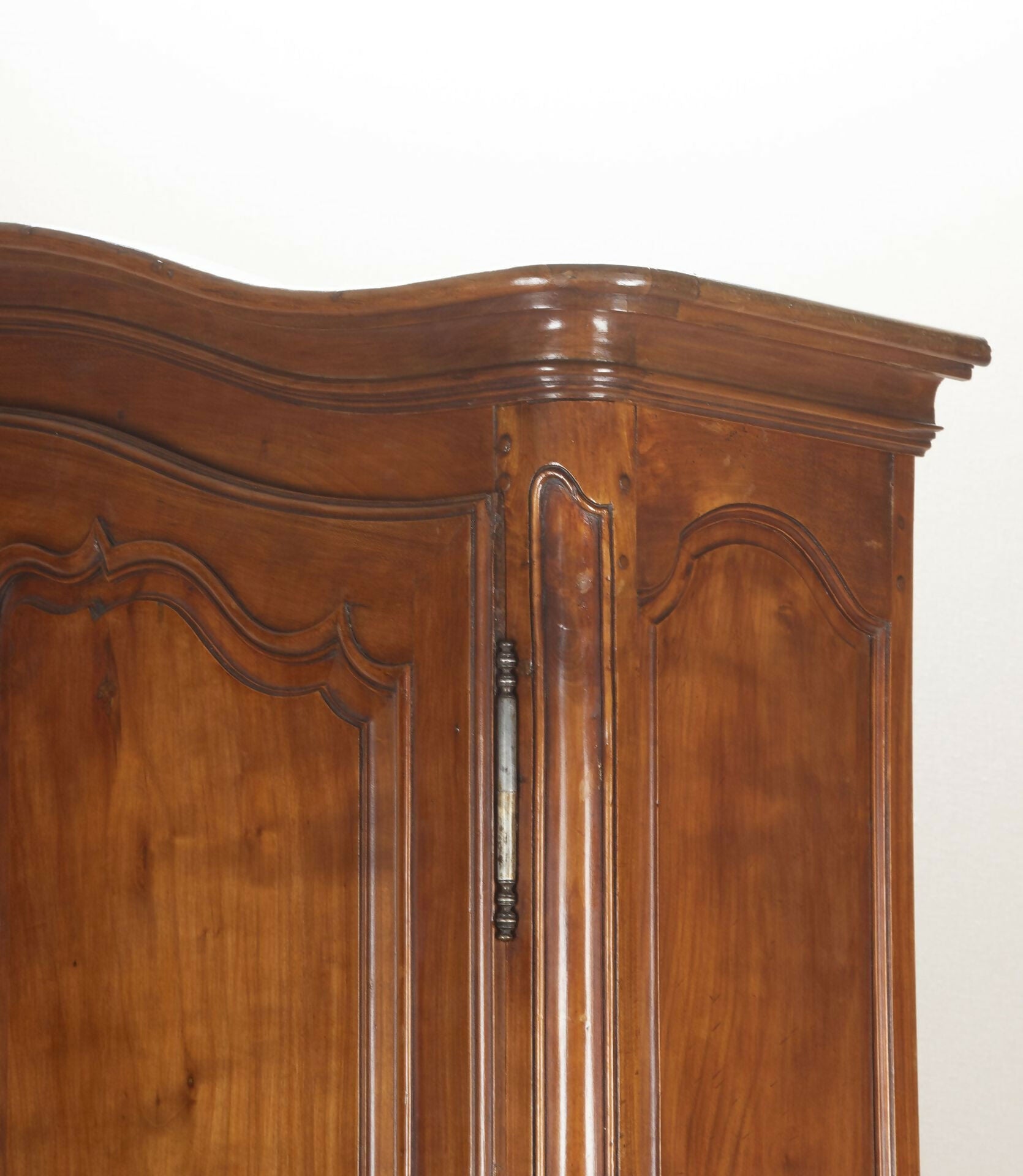 Wooden wardrobe with curved design on a white background,  available  to buy on the-salon.com. SALON curates the finest , unique, handmade pieces from the interior industry's best makers and brands. Shop luxury furniture, lighting, rugs, art, antiques and vintage pieces and accessories from SALON interior designed rooms.