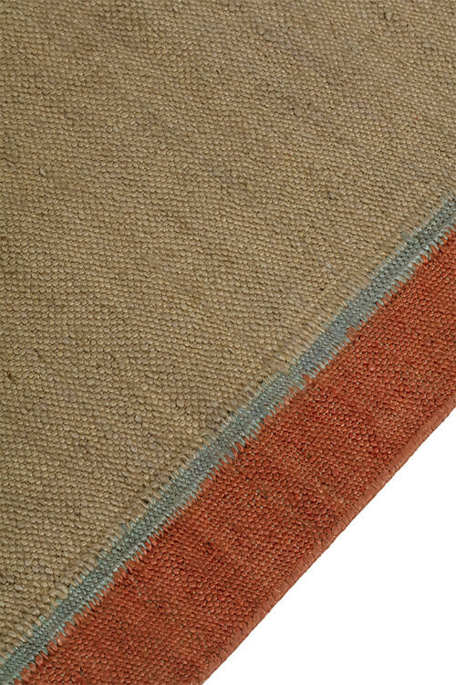 Close-up view of a hand-woven dhurrie rug with a plain texture and a visible border,  available  to buy on the-salon.com. SALON curates the finest , unique, handmade pieces from the interior industry's best makers and brands. Shop luxury furniture, lighting, rugs, art, antiques and vintage pieces and accessories from SALON interior d