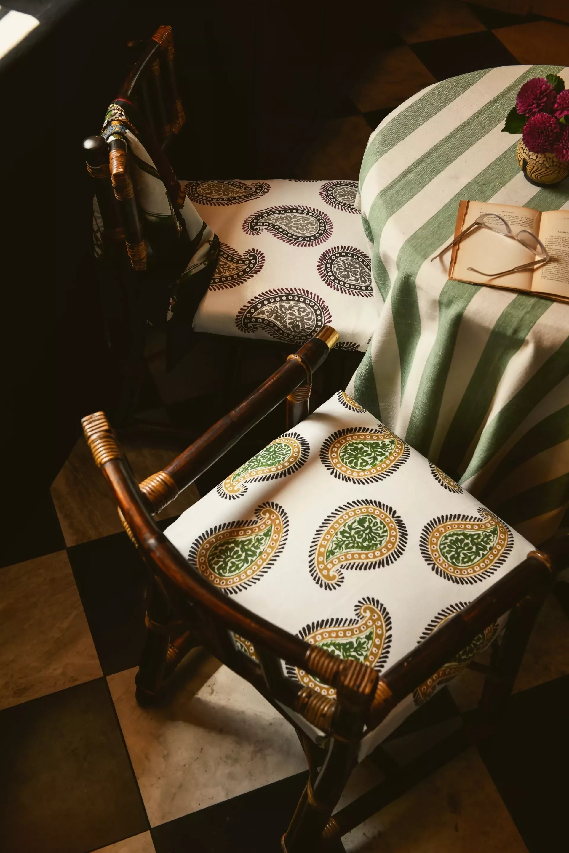 Two chairs with paisley patterned fabric with a design consisting of teardrop shapes and floral elements, predominantly in dark colors on a light background, available  to buy on the-salon.com. SALON curates the finest , unique, handmade pieces from the interior industry's best makers and brands. Shop luxury furniture, lighting, rugs, art, antiques and vintage pieces and accessories from SALON interior designed rooms