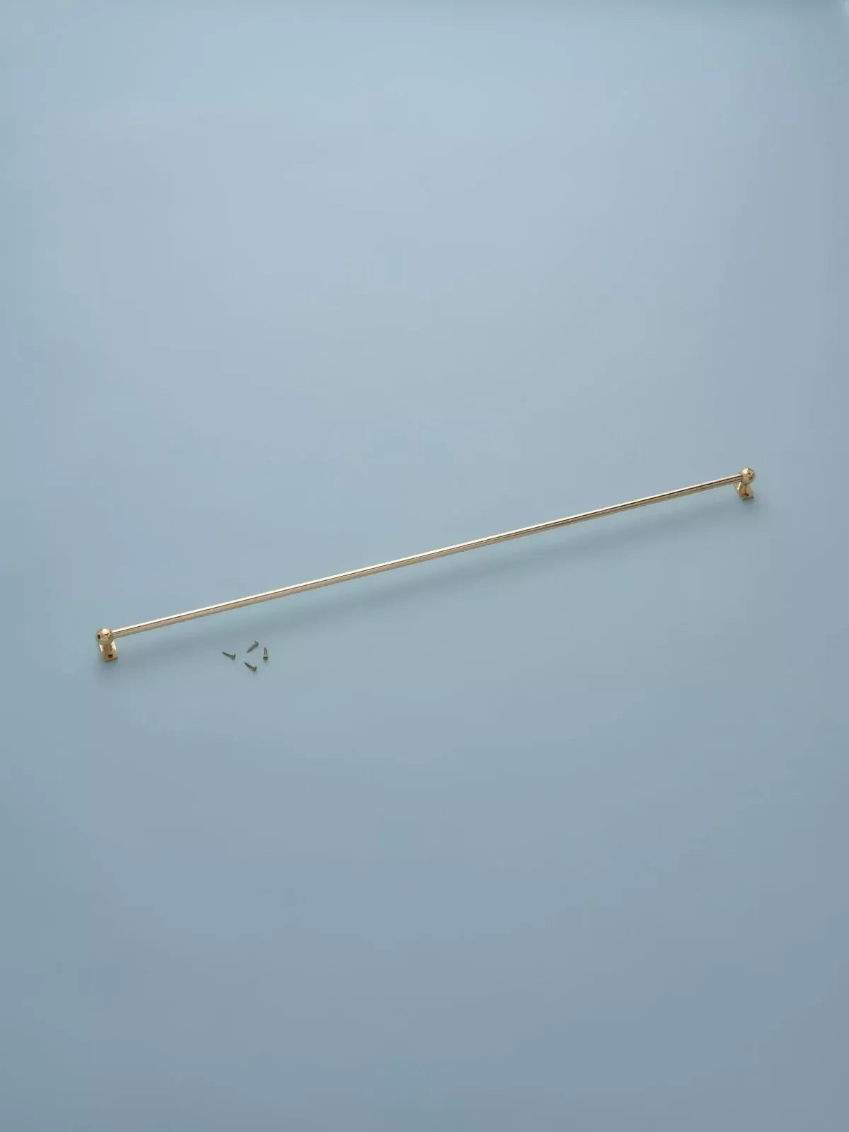 Gold curtain rod on a light blue background,  available  to buy on the-salon.com. SALON curates the finest , unique, handmade pieces from the interior industry's best makers and brands. Shop luxury furniture, lighting, rugs, art, antiques and vintage pieces and accessories from SALON interior designed rooms.