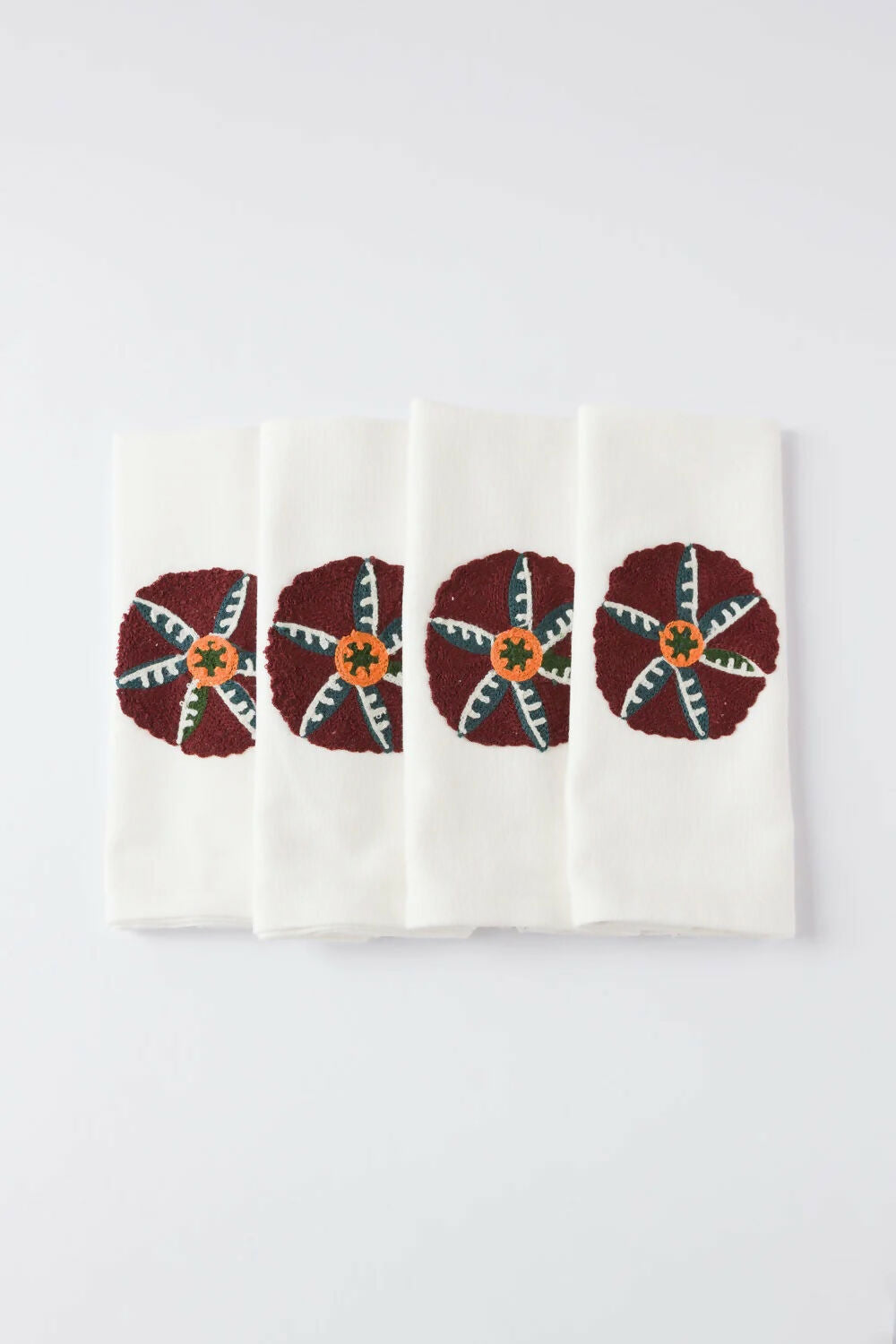 Set of four napkins with decorative patterns on a white background, available  to buy on the-salon.com. SALON curates the finest , unique, handmade pieces from the interior industry's best makers and brands. Shop luxury furniture, lighting, rugs, art, antiques and vintage pieces and accessories from SALON interior designed rooms.