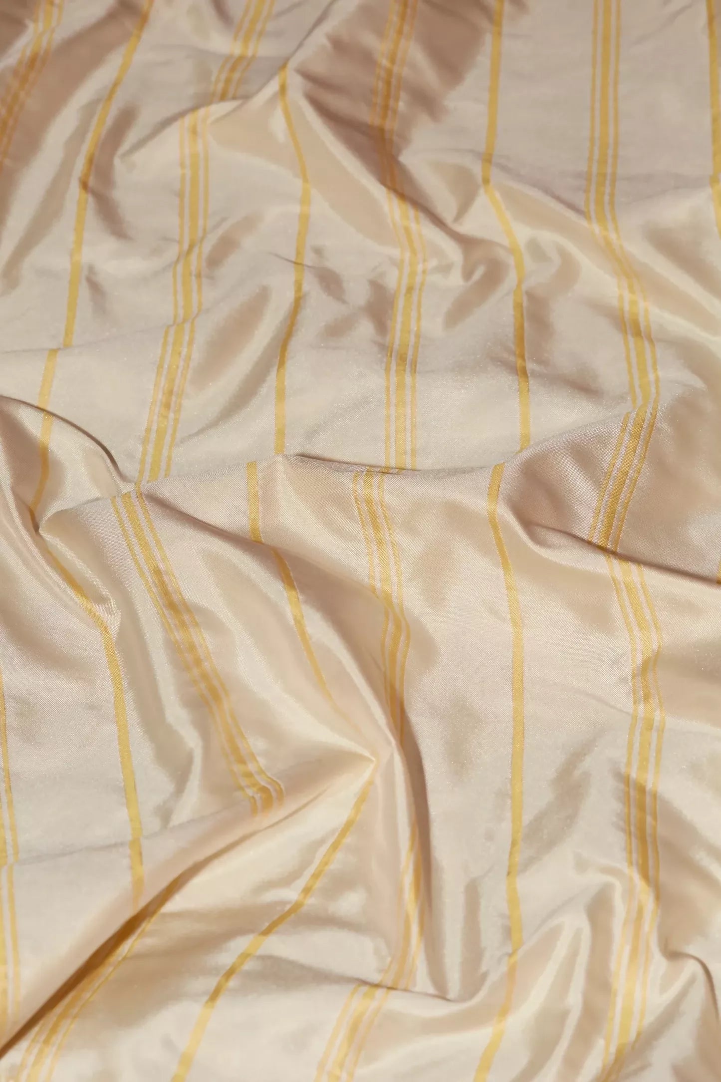 A close-up image of a yellow taffeta stripe fabric with a pin stripe pattern reversed,  available  to buy on the-salon.com. SALON curates the finest , unique, handmade pieces from the interior industry's best makers and brands. Shop luxury furniture, lighting, rugs, art, antiques and vintage pieces and accessories from SALON interior designed rooms.