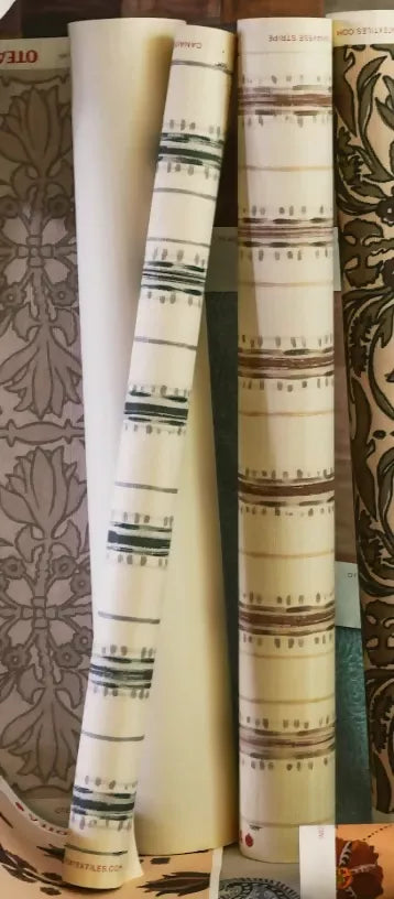 Close-up view of a textile fabric with a striped pattern featuring various shades of green and brown,available  to buy on the-salon.com. SALON curates the finest , unique, handmade pieces from the interior industry's best makers and brands. Shop luxury furniture, lighting, rugs, art, antiques and vintage pieces and accessories from SALON interior designed rooms