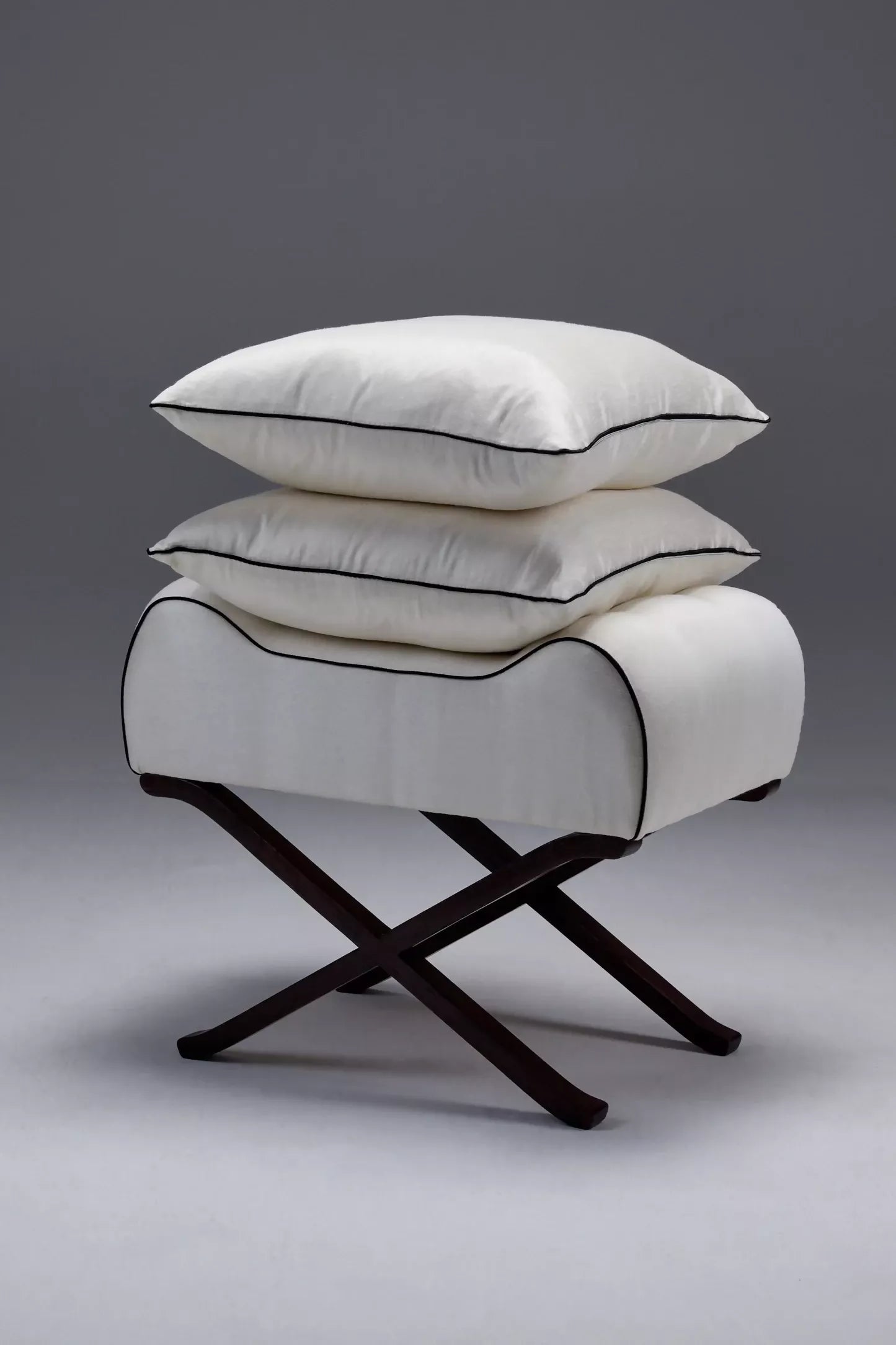 White pillow on a cross-legged sateen  available  to buy on the-salon.com. SALON curates the finest , unique, handmade pieces from the interior industry's best makers and brands. Shop luxury furniture, lighting, rugs, art, antiques and vintage pieces and accessories from SALON interior designed rooms.