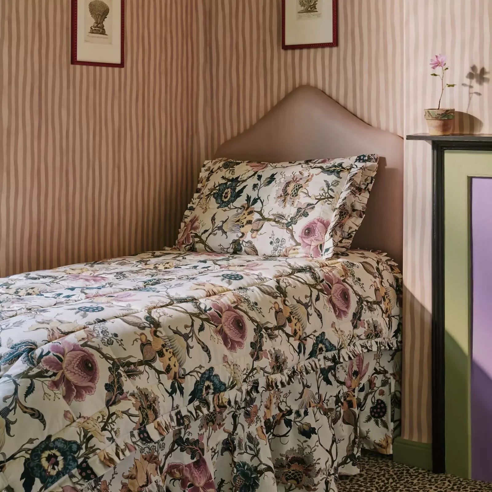 Bed with floral bedding in a room with striped walls ,available to buy from the-salon.com. SALON curates the finest unique handmade pieces from the interior industry's best makers and brands. Shop luxury furniture, lighting, rugs, art, antiques and vintage pieces and accessories from SALON interior designed rooms. 