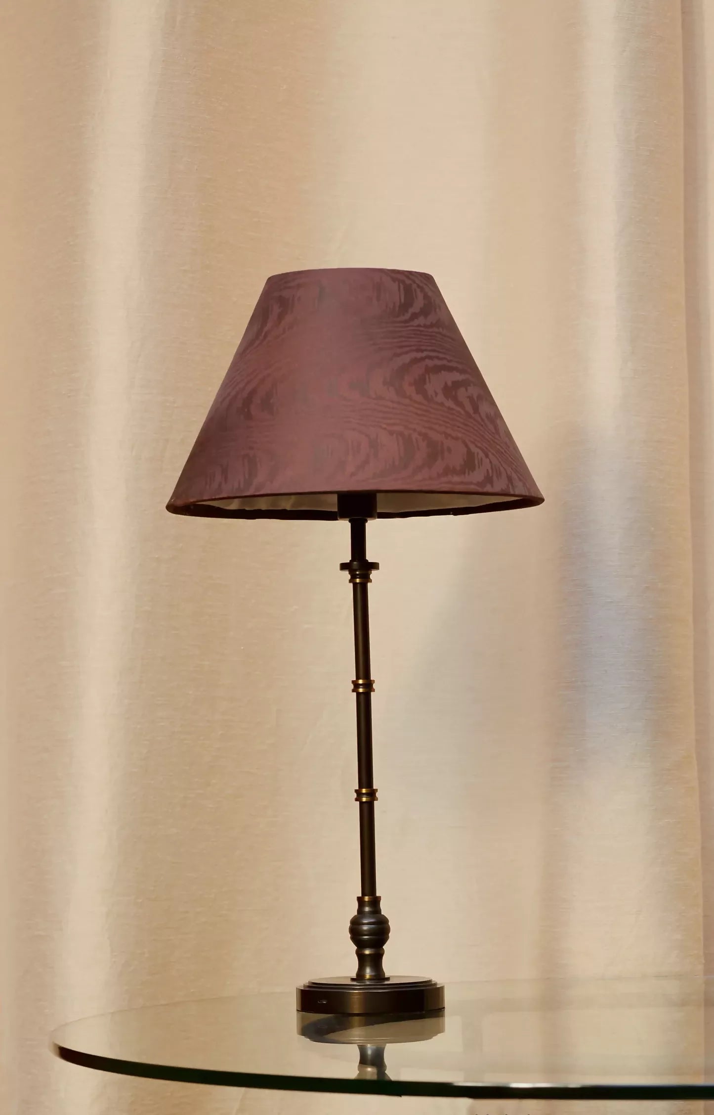 Close-up view of a brown moiré patterned fabric on a lampshade,  available  to buy on the-salon.com. SALON curates the finest , unique, handmade pieces from the interior industry's best makers and brands. Shop luxury furniture, lighting, rugs, art, antiques and vintage pieces and accessories from SALON interior designed rooms.
