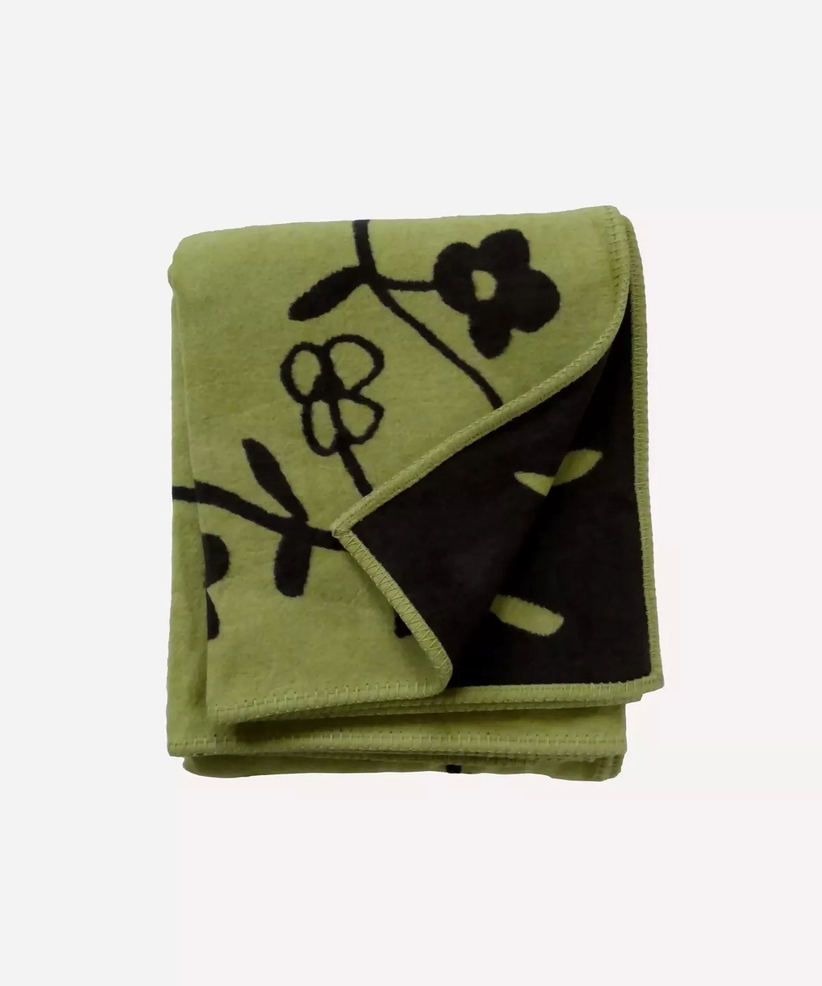 A folded beige cotton blanket with 'SWEET DREAMS' embroidered on it, displayed outdoors,  available  to buy on the-salon.com. SALON curates the finest , unique, handmade pieces from the interior industry's best makers and brands. Shop luxury furniture, lighting, rugs, art, antiques and vintage pieces and accessories from SALON interior designed rooms.