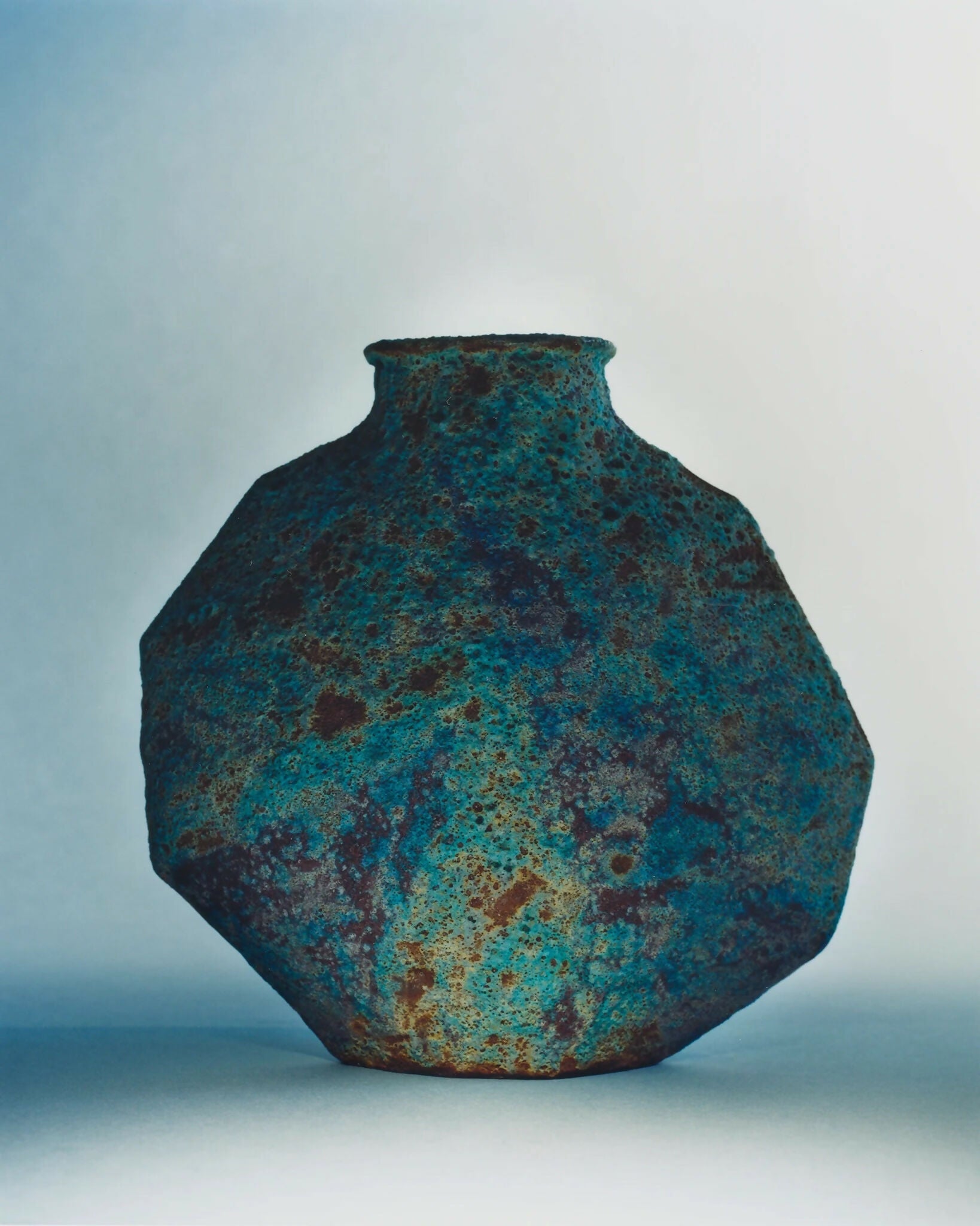 A ceramic vase with an angular form and a vibrant textural glaze in turquoise, blue, and subtle green tones,  available  to buy on the-salon.com. SALON curates the finest , unique, handmade pieces from the interior industry's best makers and brands. Shop luxury furniture, lighting, rugs, art, antiques and vintage pieces and accessories from SALON interior designed rooms.