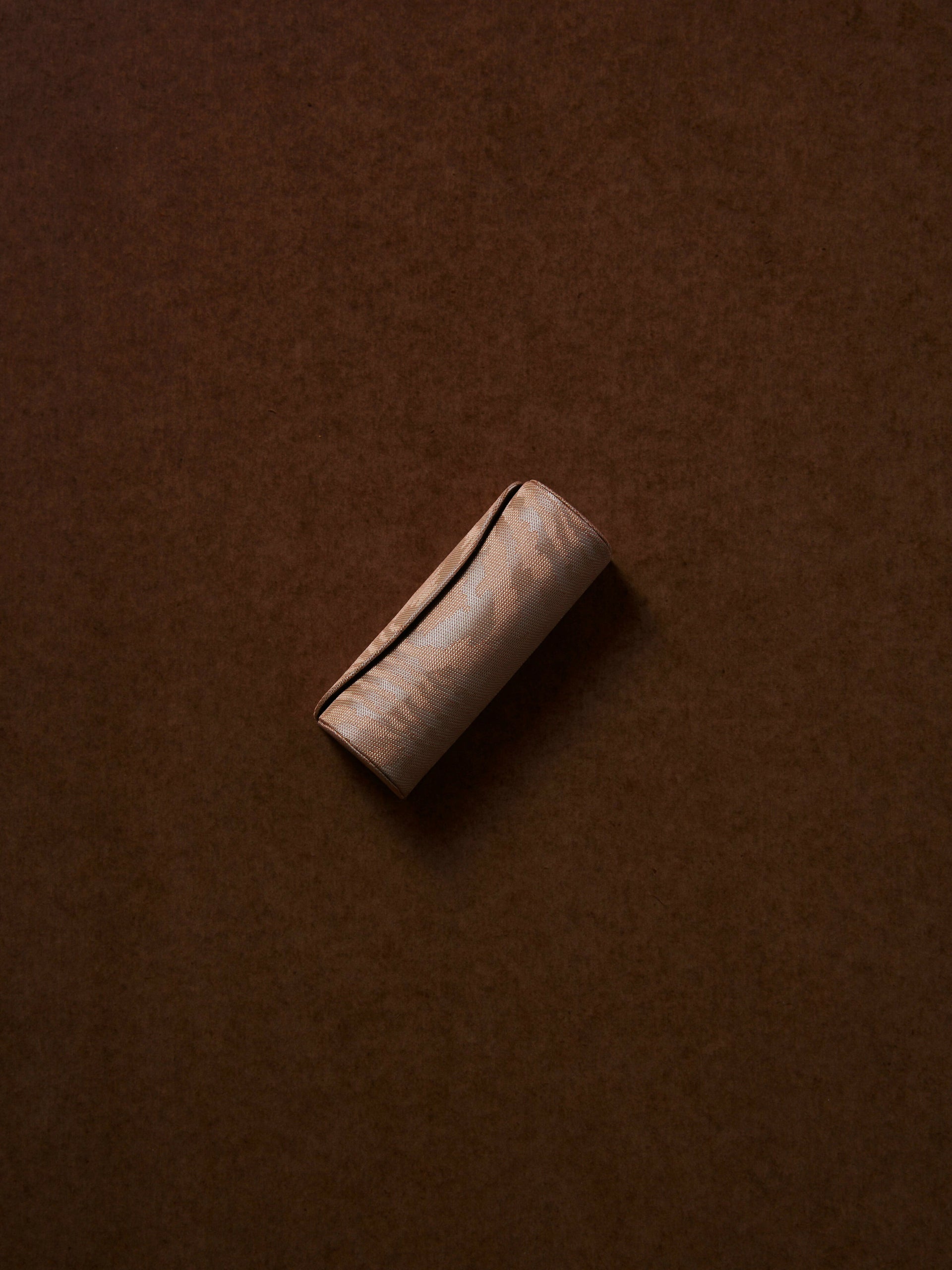 Brown leather wallet on a brown background,  available  to buy on the-salon.com. SALON curates the finest , unique, handmade pieces from the interior industry's best makers and brands. Shop luxury furniture, lighting, rugs, art, antiques and vintage pieces and accessories from SALON interior designed rooms.
