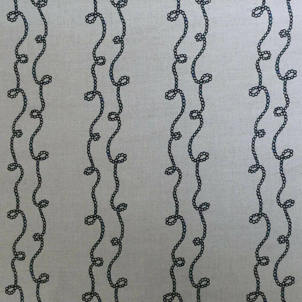 A swatch of fabric featuring a white background with a blue geometric pattern consisting of twisted shapes,  available  to buy on the-salon.com. SALON curates the finest , unique, handmade pieces from the interior industry's best makers and brands. Shop luxury furniture, lighting, rugs, art, antiques and vintage pieces and accessories from SALON interior designed rooms.