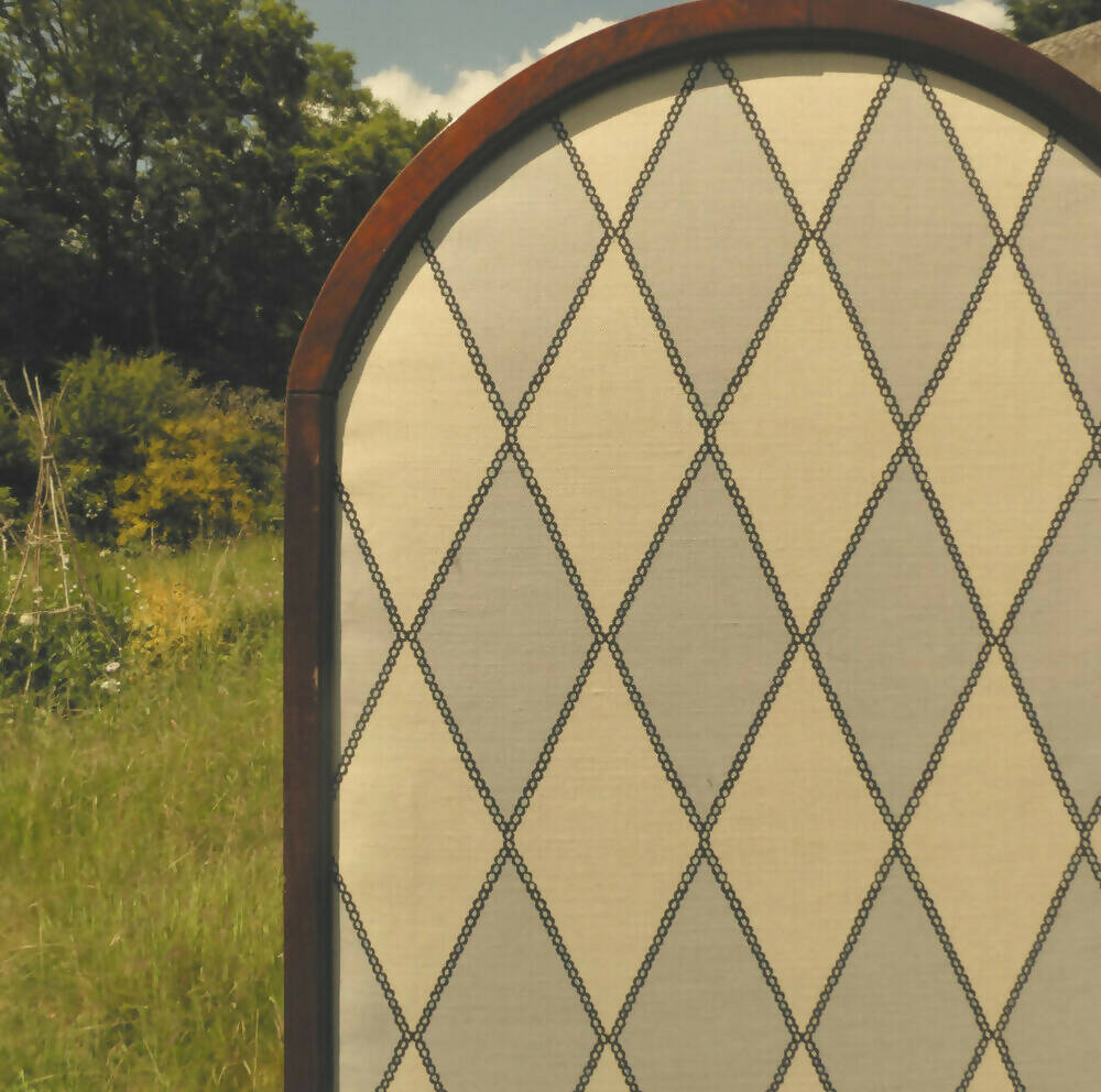 Close-up of a fabric with a geometric harlequin pattern in pearl white and grey colors, available  to buy on the-salon.com. SALON curates the finest , unique, handmade pieces from the interior industry's best makers and brands. Shop luxury furniture, lighting, rugs, art, antiques and vintage pieces and accessories from SALON interior designed rooms.