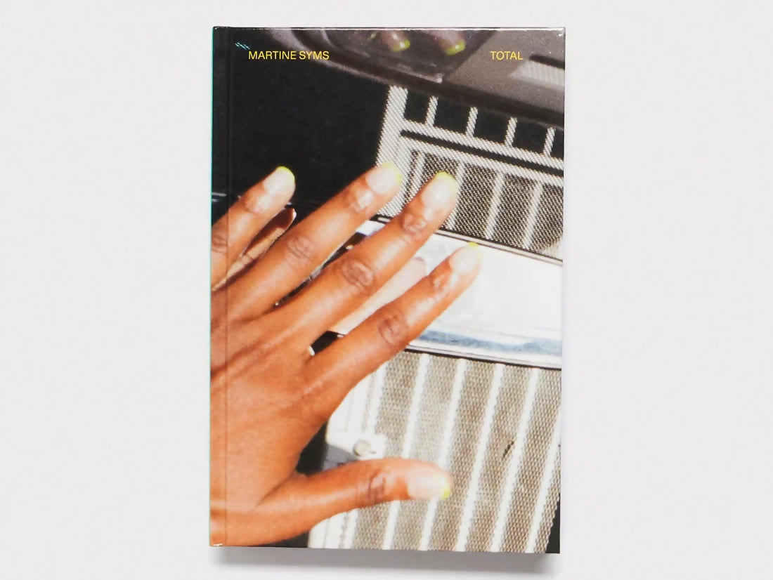 Cover of the 'TOTAL' catalog featuring Martine Syms' artwork, with a close-up of a hand on a keyboard,  available  to buy on the-salon.com. SALON curates the finest , unique, handmade pieces from the interior industry's best makers and brands. Shop luxury furniture, lighting, rugs, art, antiques and vintage pieces and accessories from SALON interior designed rooms.