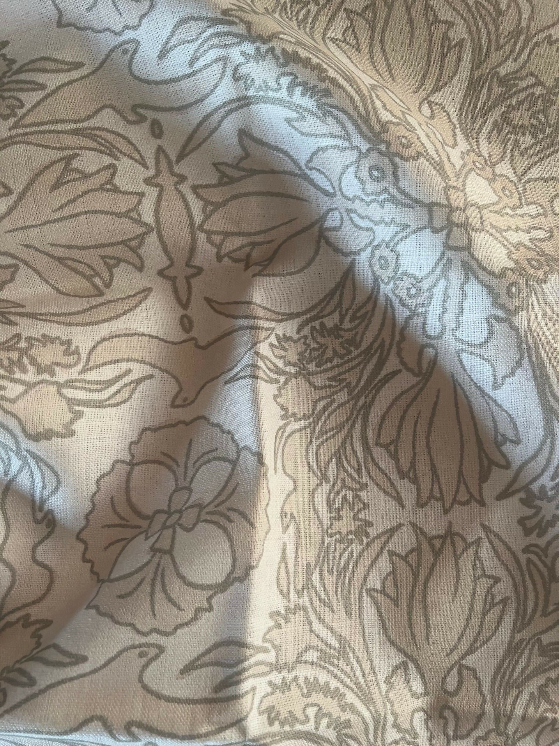 A close-up view of a vintage scarf fabric featuring a detailed and ornate floral pattern in shades of black and gray on a beige background,  available  to buy on the-salon.com. SALON curates the finest , unique, handmade pieces from the interior industry's best makers and brands. Shop luxury furniture, lighting, rugs, art, antiques and vintage pieces and accessories from SALON interior designed rooms.