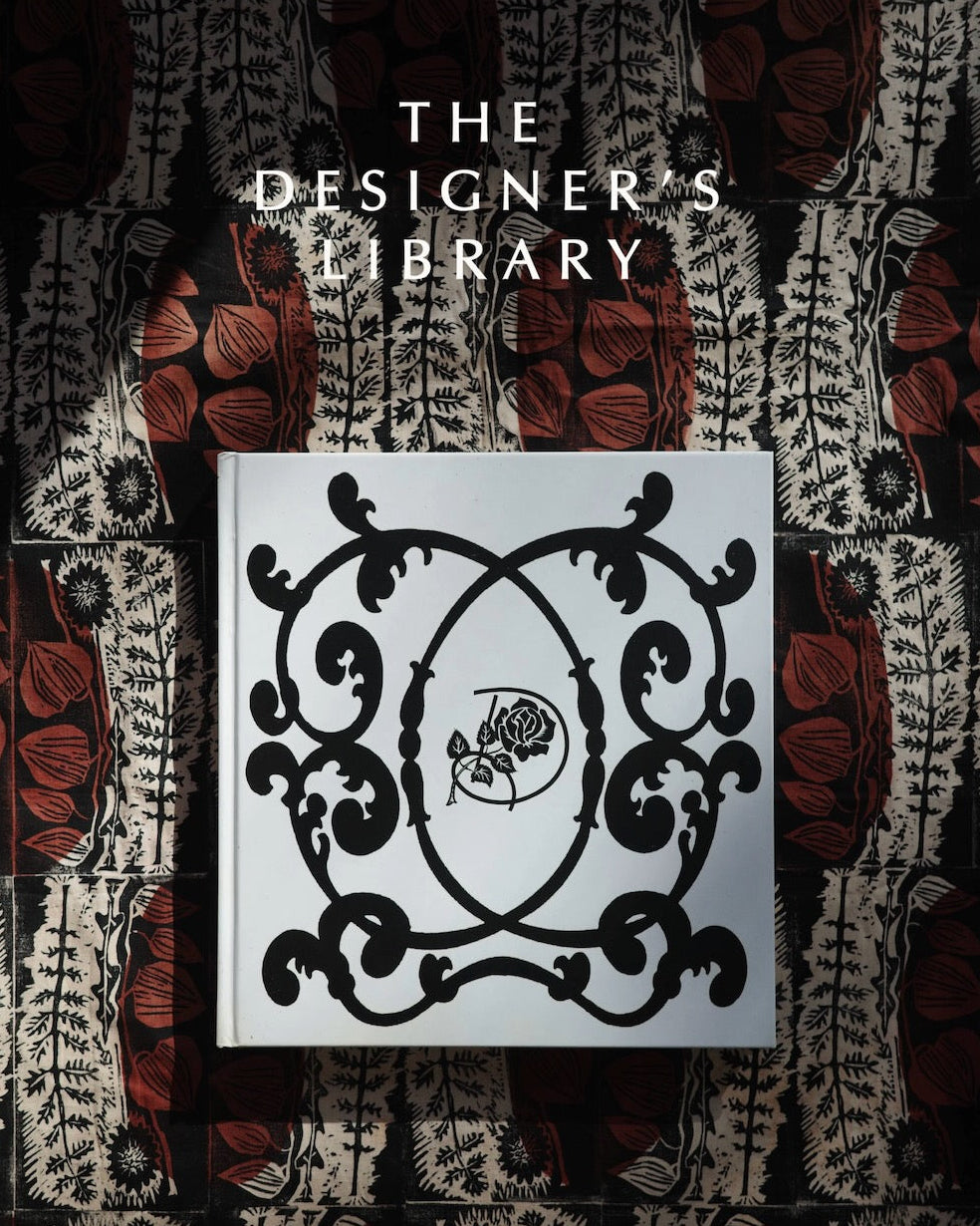 Cover of 'The Designer's Library Salon' with decorative emblem and intricate patterns.