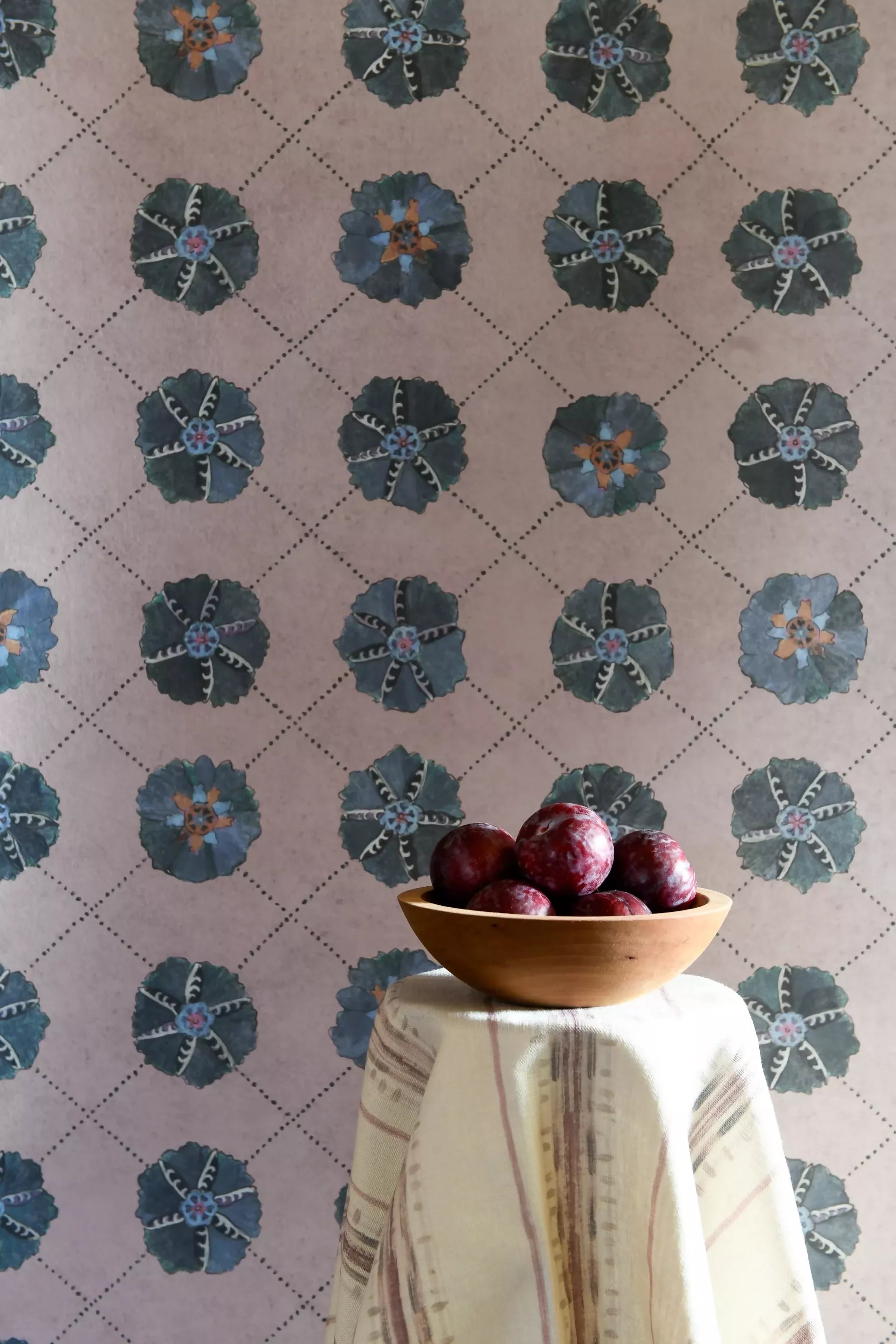 SUZANI wallpaper on the walls, showing off the blue flower designs in the middle, with a fruit bowl in the foreground, available  to buy on the-salon.com. SALON curates the finest , unique, handmade pieces from the interior industry's best makers and brands. Shop luxury furniture, lighting, rugs, art, antiques and vintage pieces and accessories from SALON interior designed rooms.