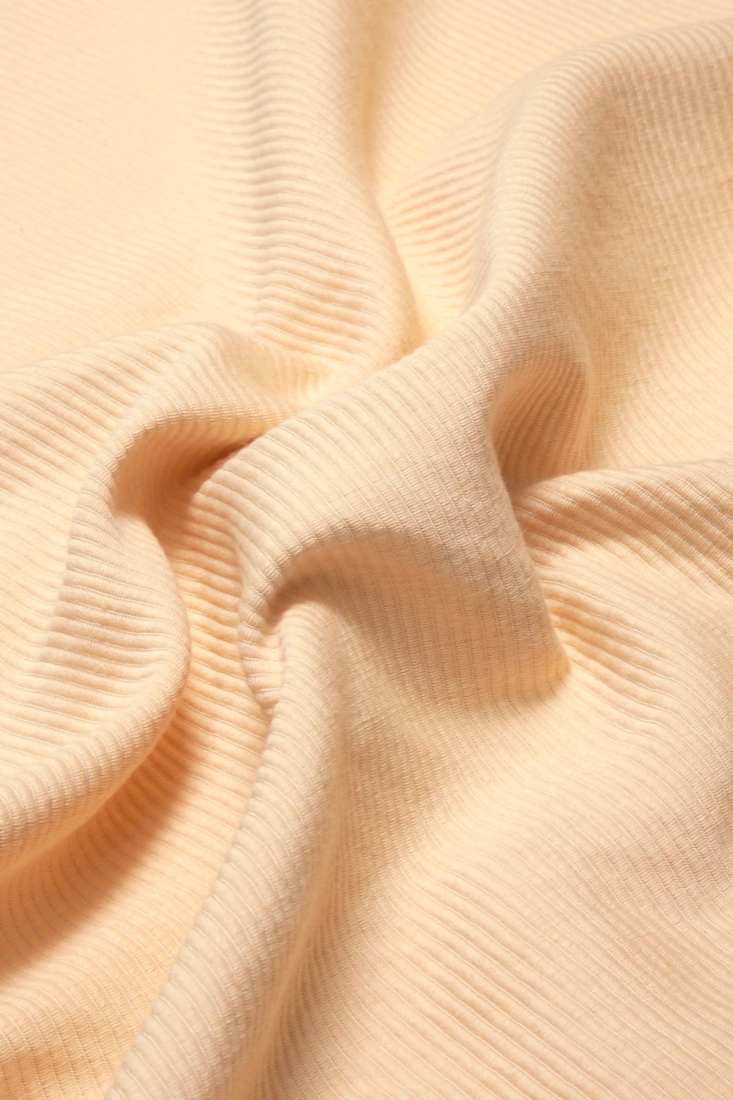 A close-up image of a beige fabric with a textured weave, showcasing its glossy and detailed aspects,  available  to buy on the-salon.com. SALON curates the finest , unique, handmade pieces from the interior industry's best makers and brands. Shop luxury furniture, lighting, rugs, art, antiques and vintage pieces and accessories from SALON interior designed rooms.