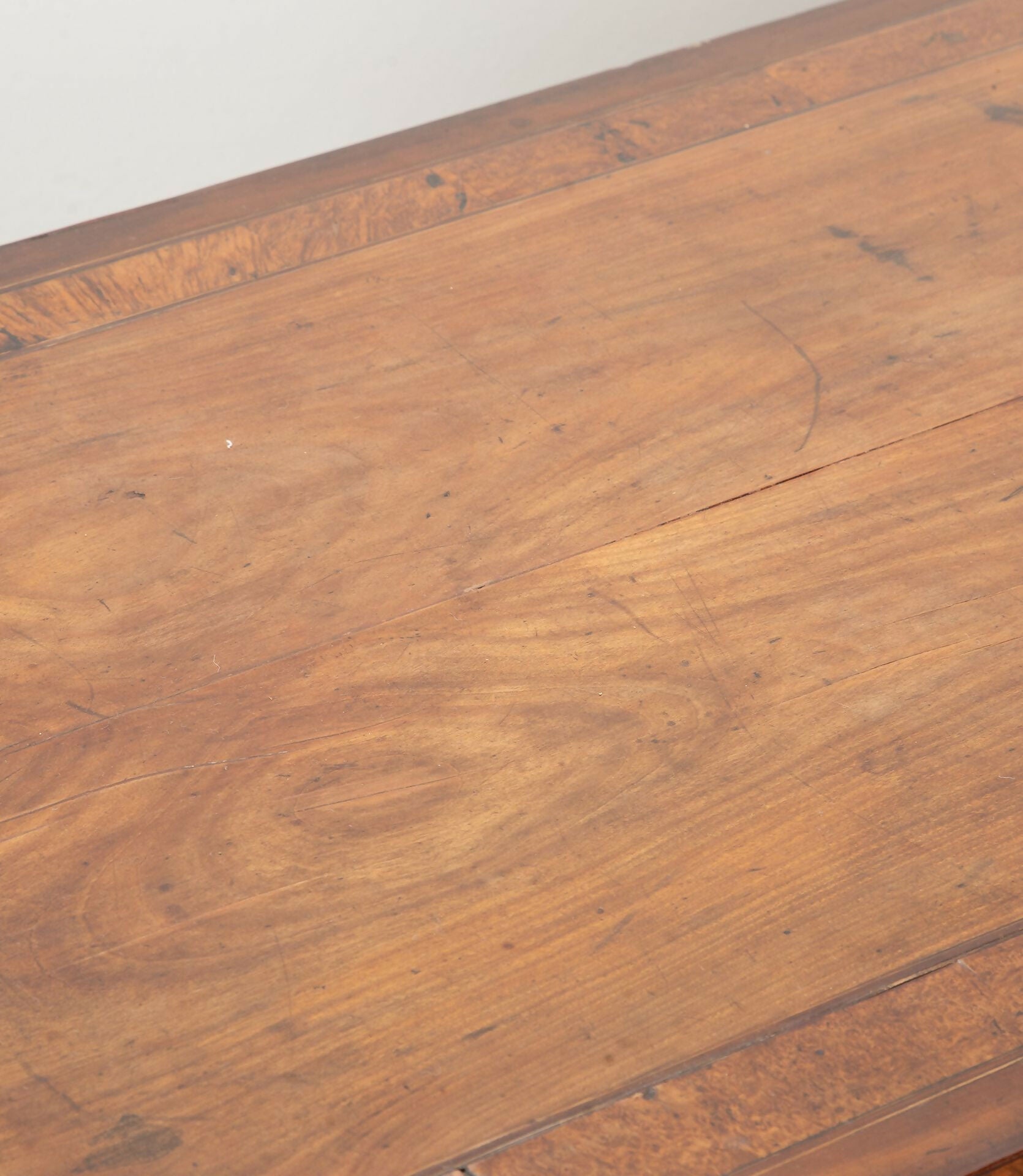 Close-up of a wooden surface with visible grain and texture,  available  to buy on the-salon.com. SALON curates the finest , unique, handmade pieces from the interior industry's best makers and brands. Shop luxury furniture, lighting, rugs, art, antiques and vintage pieces and accessories from SALON interior designed rooms.