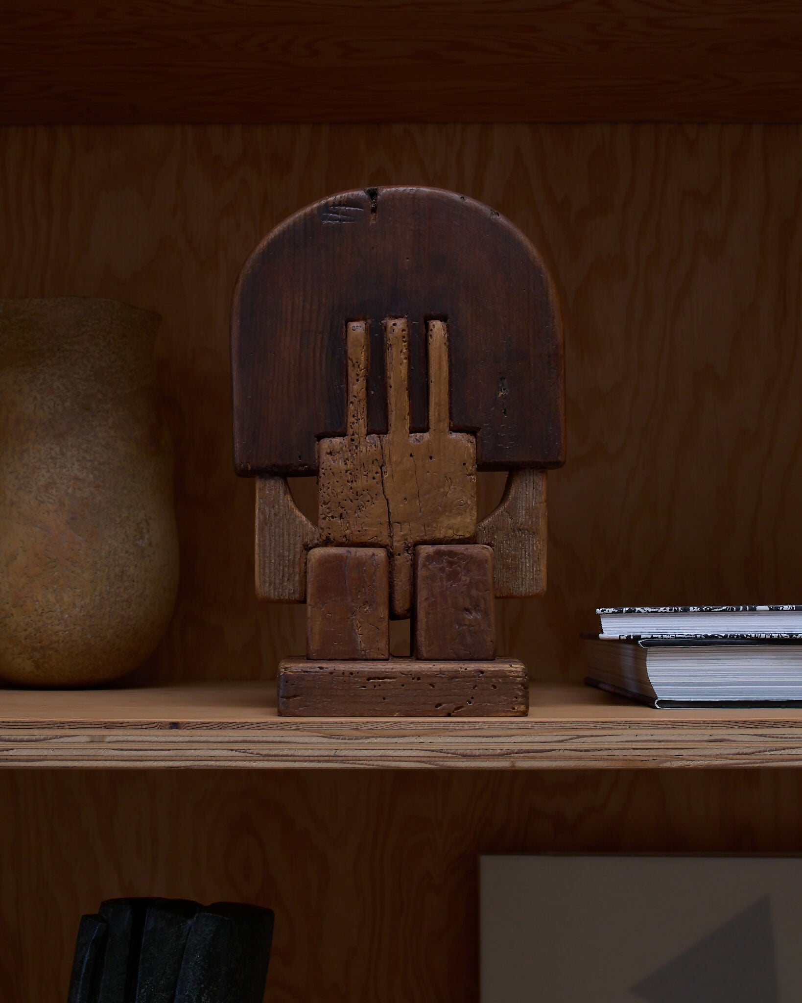 A hand-carved wooden sculpture by Adolf Vallazza, featuring an abstract figure with interlocking forms, with a dark brown to black color, available  to buy on the-salon.com. SALON curates the finest , unique, handmade pieces from the interior industry's best makers and brands. Shop luxury furniture, lighting, rugs, art, antiques and vintage pieces and accessories from SALON interior designed rooms.