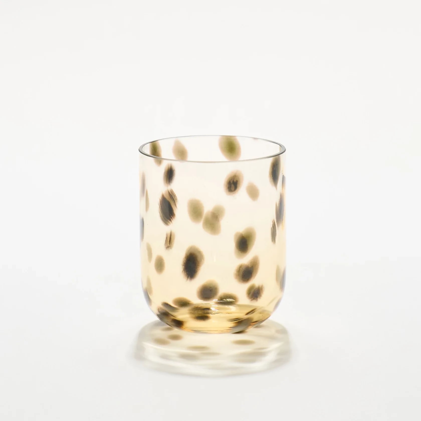 Glass with gold and black spotted pattern on a white background- available  to buy on the-salon.com. SALON curates the finest , unique, handmade pieces from the interior industry's best makers and brands. Shop luxury furniture, lighting, rugs, art, antiques and vintage pieces and accessories from SALON interior designed rooms.