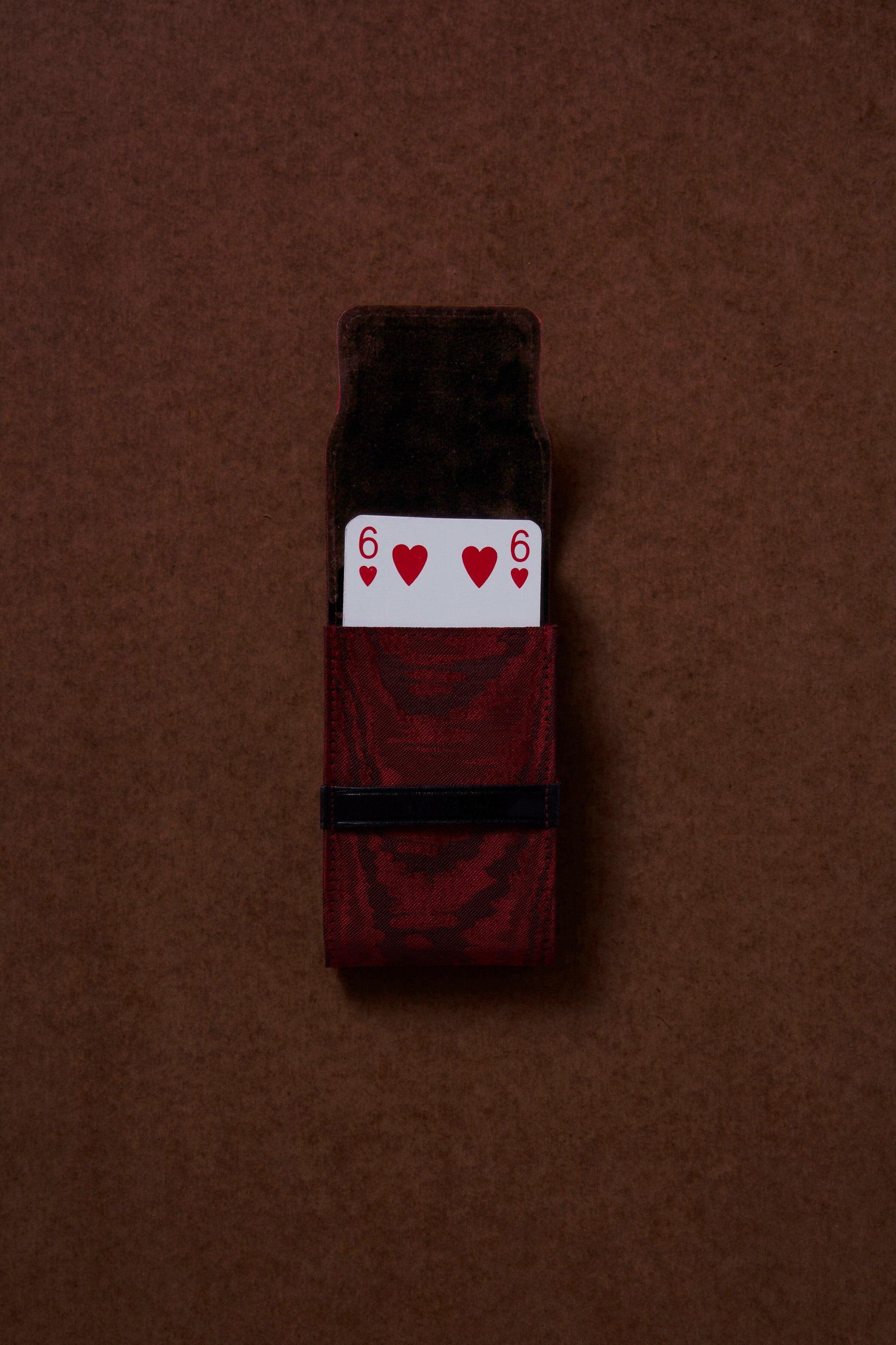 Maroon socks with a card design on a brown background,  available  to buy on the-salon.com. SALON curates the finest , unique, handmade pieces from the interior industry's best makers and brands. Shop luxury furniture, lighting, rugs, art, antiques and vintage pieces and accessories from SALON interior designed rooms.