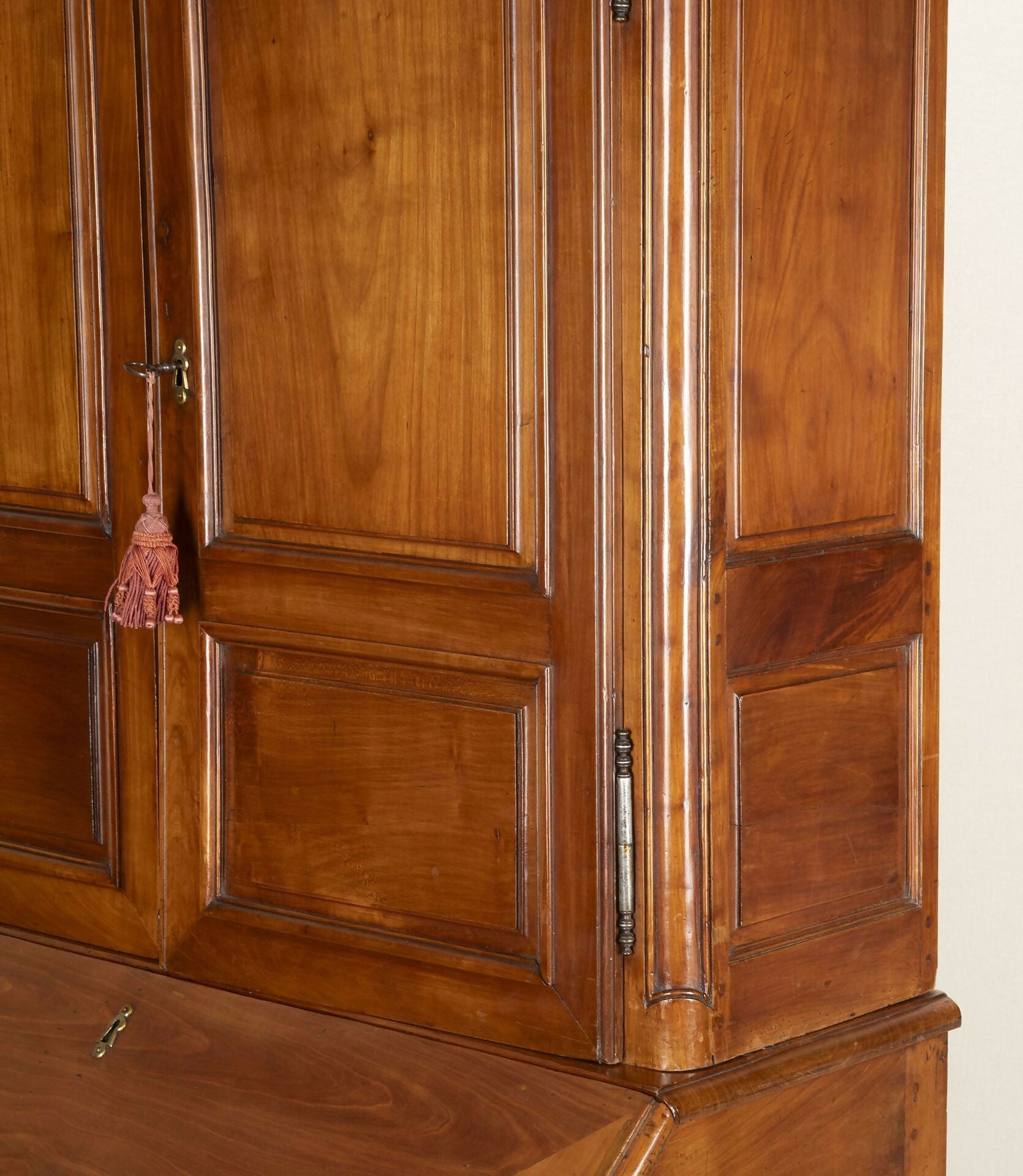 Close-up of a wooden wardrobe with a pink decorative item on a beige background,  available  to buy on the-salon.com. SALON curates the finest , unique, handmade pieces from the interior industry's best makers and brands. Shop luxury furniture, lighting, rugs, art, antiques and vintage pieces and accessories from SALON interior designed rooms.
