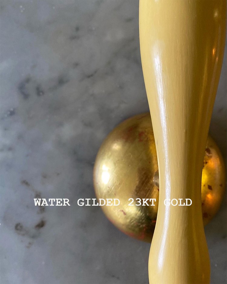 A wall-mounted light fixture with a yellow painted stem and a white conical lampshade, with a gold-look wall plate, available  to buy on the-salon.com. SALON curates the finest , unique, handmade pieces from the interior industry's best makers and brands. Shop luxury furniture, lighting, rugs, art, antiques and vintage pieces and accessories from SALON interior designed rooms.