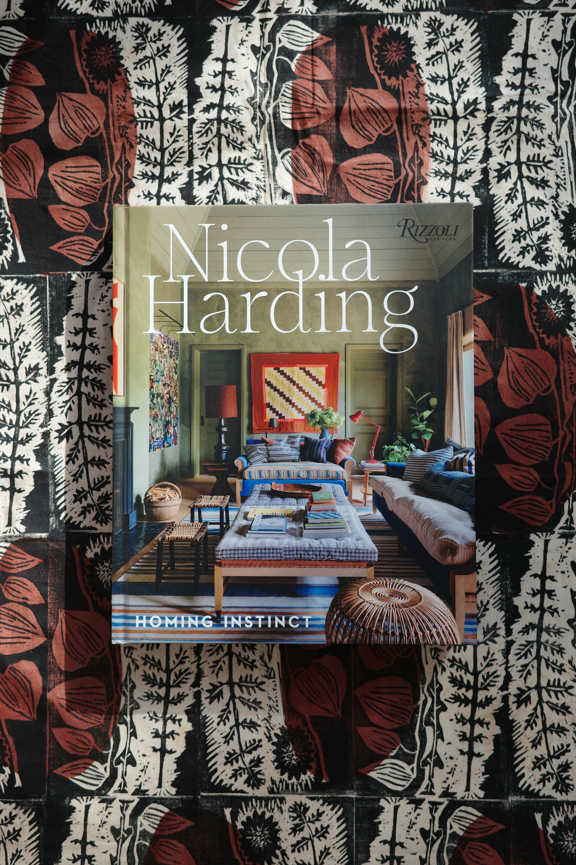 Book titled 'Nicola Harding Homing Instinct' on a patterned surface
