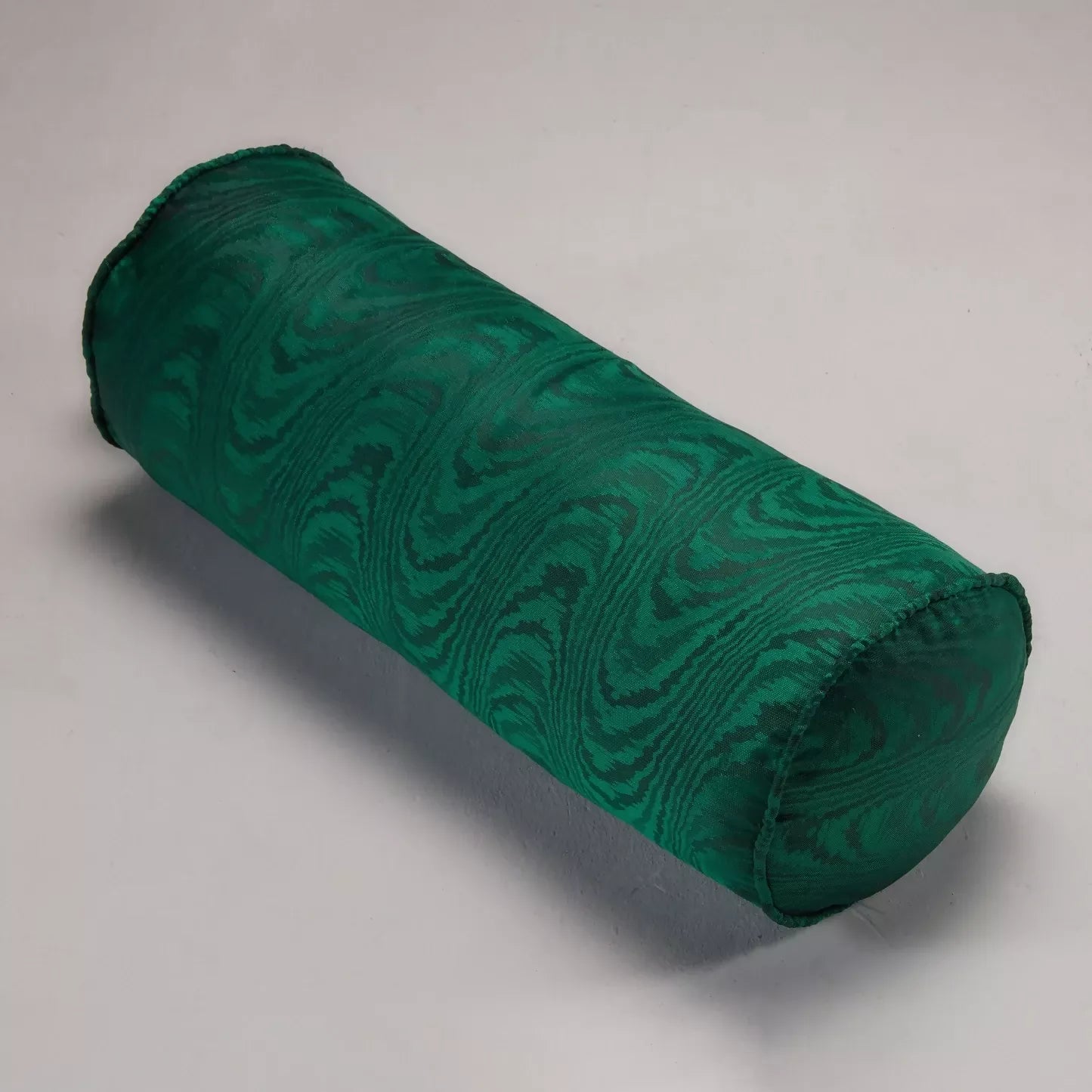 Close-up view of a green silk moiré fabric with a textured pattern,  available  to buy on the-salon.com. SALON curates the finest , unique, handmade pieces from the interior industry's best makers and brands. Shop luxury furniture, lighting, rugs, art, antiques and vintage pieces and accessories from SALON interior designed rooms.