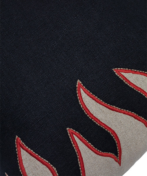 Close up of a flame pillow, available at the-salon.com. SALON curates the finest , unique, handmade pieces from the interior industry's best makers and brands. Shop luxury furniture, lighting, rugs, art, antiques and vintage pieces and accessories from SALON interior designed rooms.