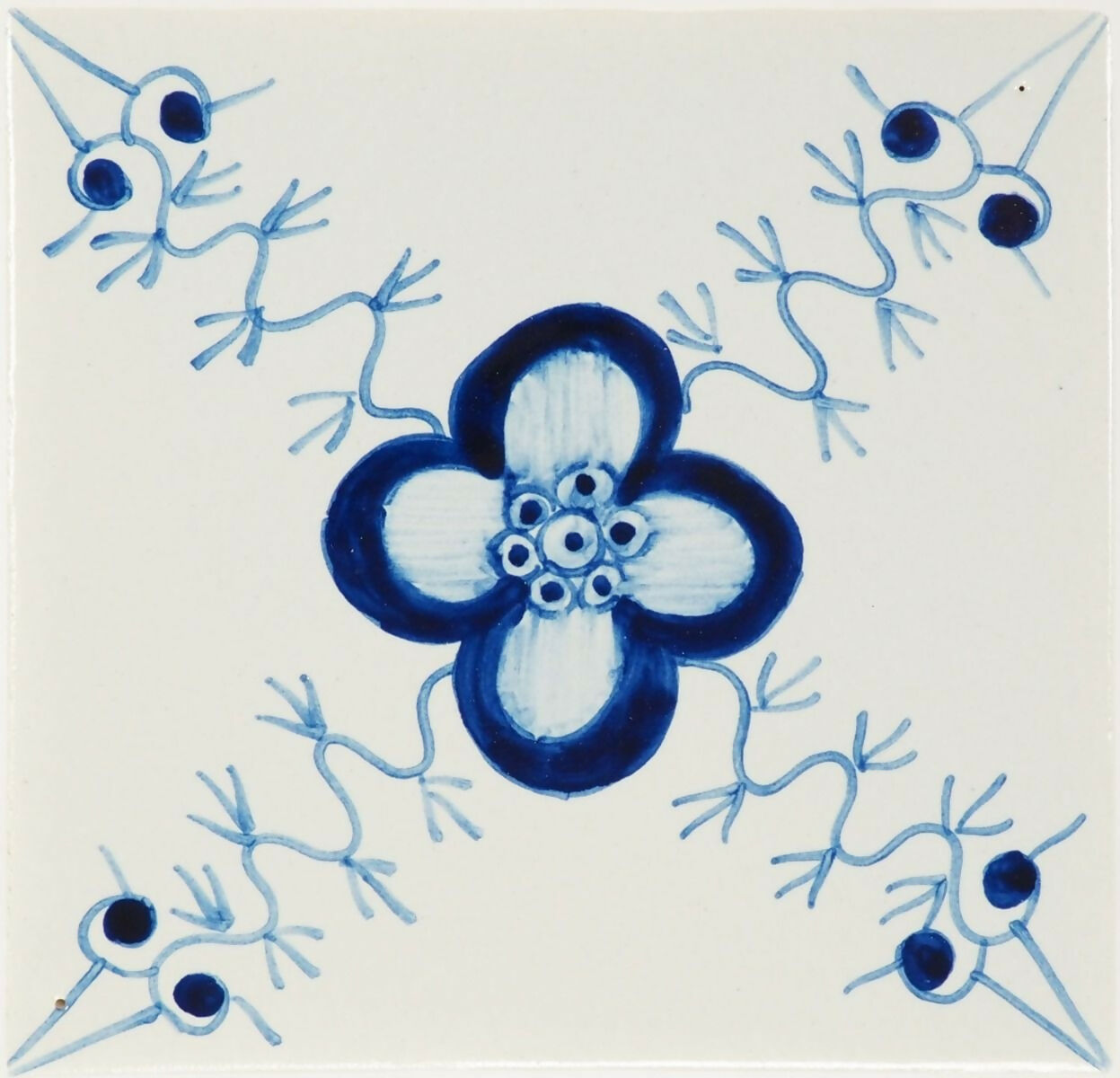 Decorative tile with a blue flower design on a white background,  available  to buy on the-salon.com. SALON curates the finest , unique, handmade pieces from the interior industry's best makers and brands. Shop luxury furniture, lighting, rugs, art, antiques and vintage pieces and accessories from SALON interior designed rooms.