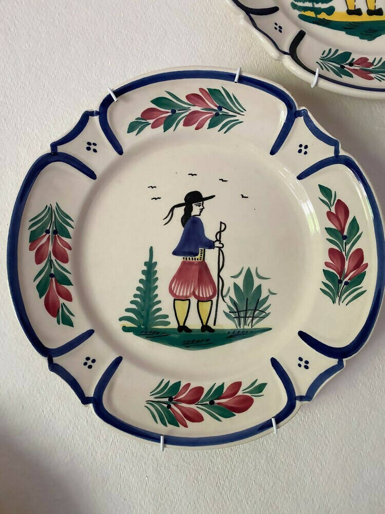 A vintage French hand painted plate with a man motif, displayed on a wall,  available  to buy on the-salon.com. SALON curates the finest , unique, handmade pieces from the interior industry's best makers and brands. Shop luxury furniture, lighting, rugs, art, antiques and vintage pieces and accessories from SALON interior designed rooms.