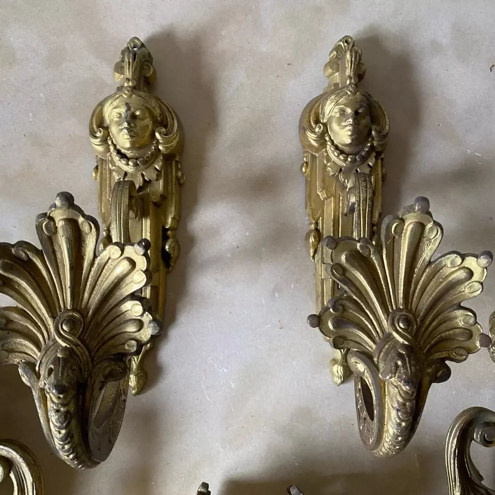 Two ornate bronze wall sconces on a marble surface available to buy from the-salon.com. SALON curates the finest unique handmade pieces from the interior industry's best makers and brands. Shop luxury furniture, lighting, rugs, art, antiques and vintage pieces and accessories from SALON interior designed rooms.