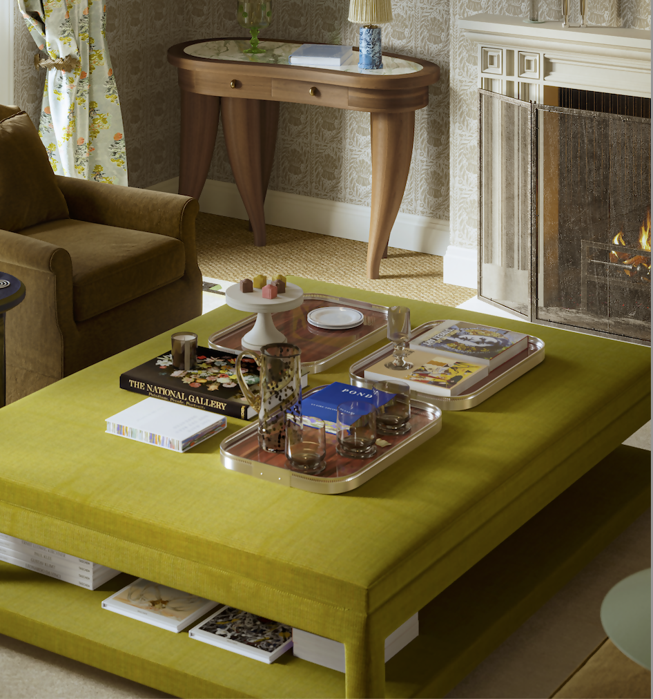A green upholstered ottoman with splayed legs and a shelf, positioned in a room with a fireplace and a side table,  available  to buy on the-salon.com. SALON curates the finest , unique, handmade pieces from the interior industry's best makers and brands. Shop luxury furniture, lighting, rugs, art, antiques and vintage pieces and accessories from SALON interior designed rooms.