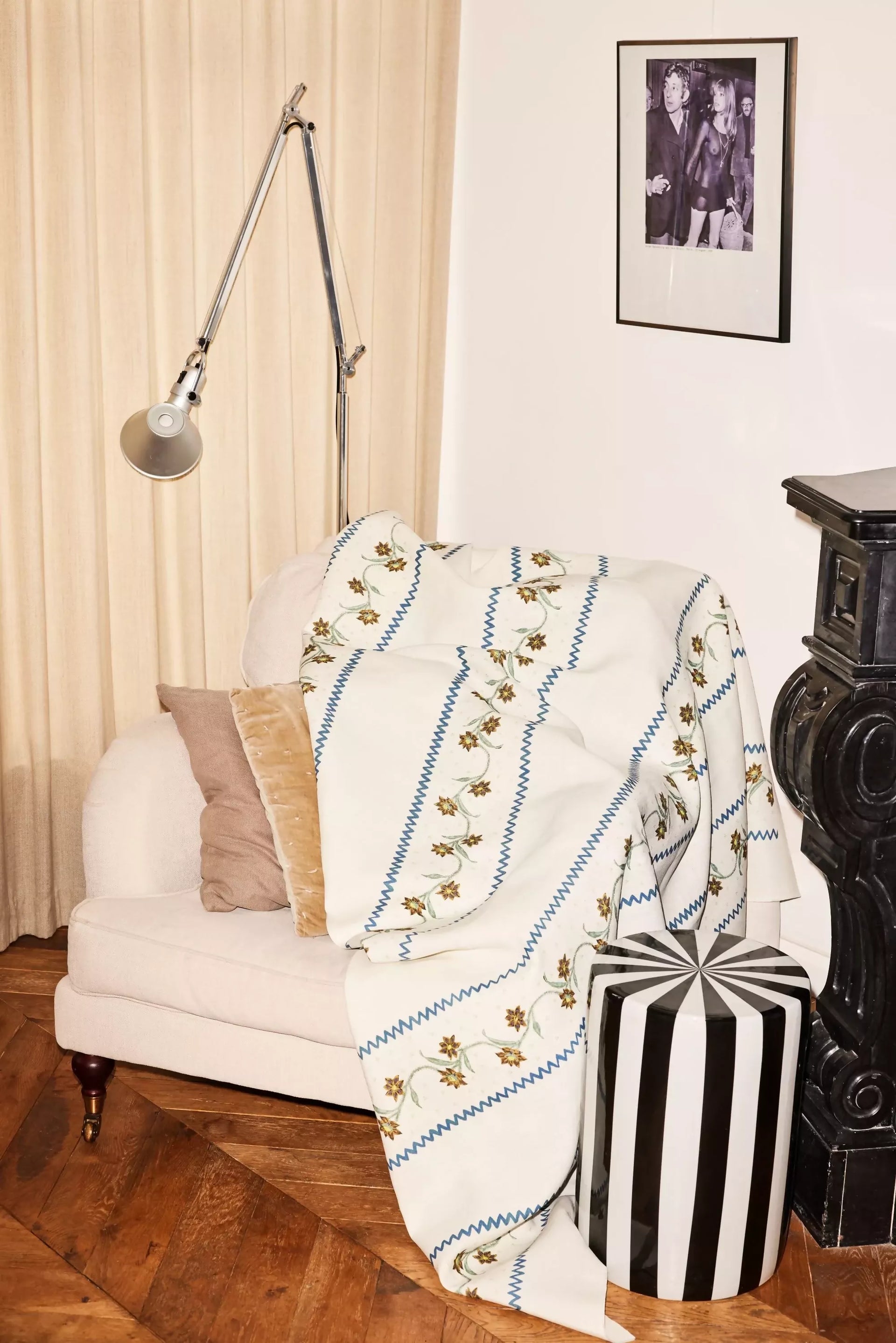 Decorative blanket with floral patterns draped over a white sofa in a living room,available to buy from the-salon.com. SALON curates the finest unique handmade pieces from the interior industry's best makers and brands. Shop luxury furniture, lighting, rugs, art, antiques and vintage pieces and accessories from SALON interior designed rooms. 