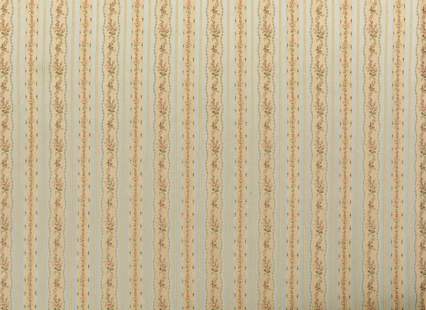 Close-up of Spitalfields stripe sky fabric featuring a jacquard weave with floral motifs and silk leaves, in a warm honey tone,  available  to buy on the-salon.com. SALON curates the finest , unique, handmade pieces from the interior industry's best makers and brands. Shop luxury furniture, lighting, rugs, art, antiques and vintage pieces and accessories from SALON interior designed rooms.