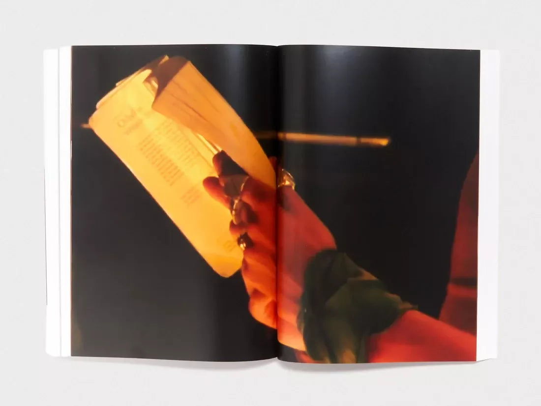An image of an open book, containing an image of hands holding. a book in mood lighting,  available  to buy on the-salon.com. SALON curates the finest , unique, handmade pieces from the interior industry's best makers and brands. Shop luxury furniture, lighting, rugs, art, antiques and vintage pieces and accessories from SALON interior designed rooms.