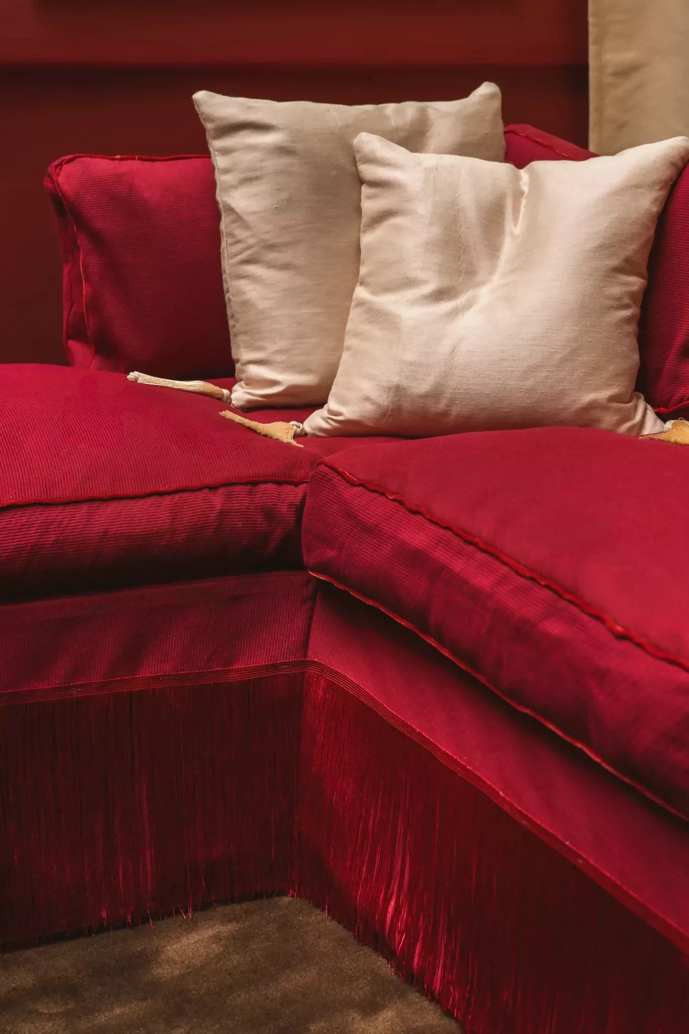 A view of a red fabric with a textured weave pattern suitable for upholstery, shown on the sofa,  available  to buy on the-salon.com. SALON curates the finest , unique, handmade pieces from the interior industry's best makers and brands. Shop luxury furniture, lighting, rugs, art, antiques and vintage pieces and accessories from SALON interior designed rooms.