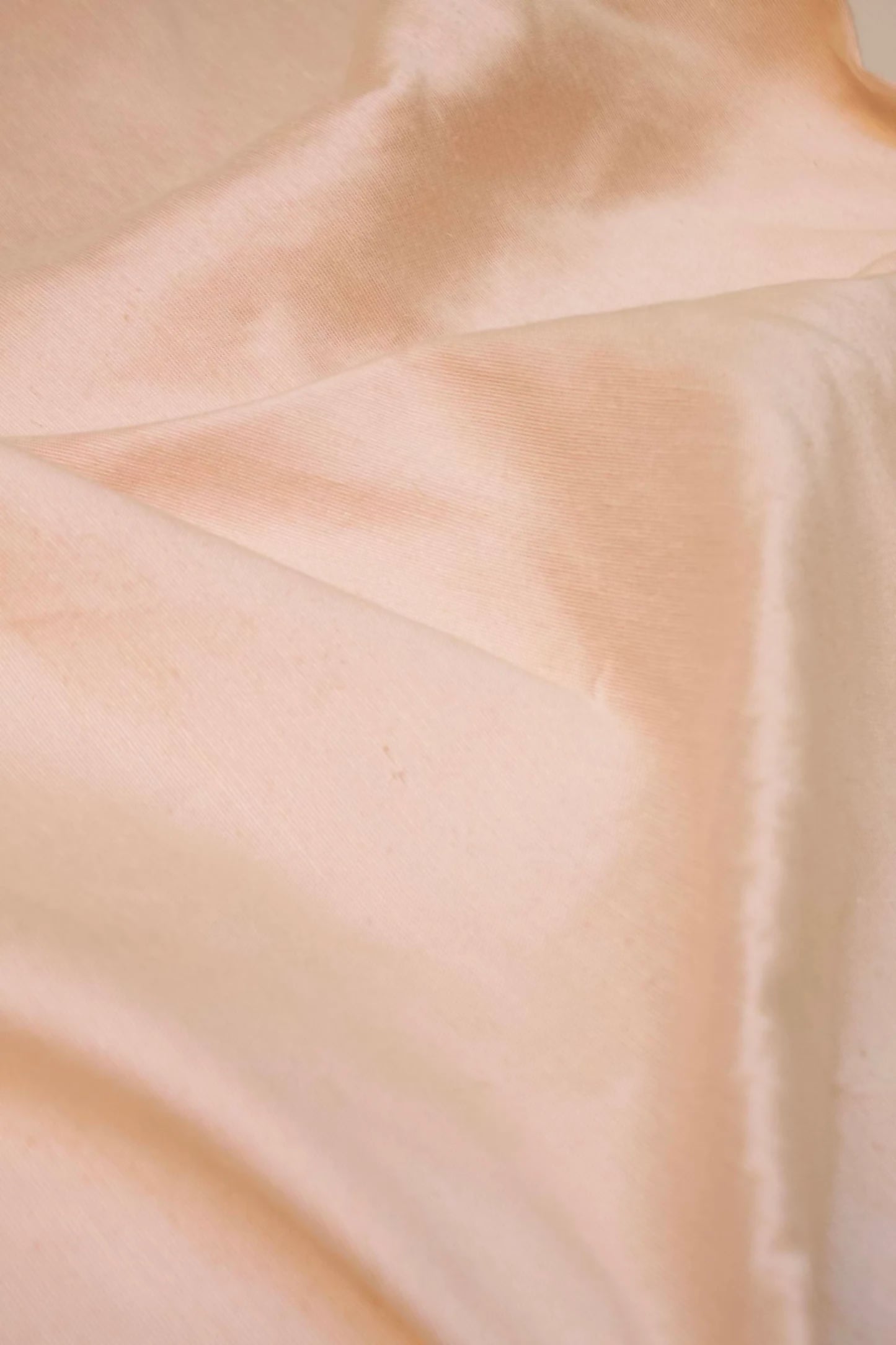 Close-up of a pink silk sateen fabric with a slight sheen due to the silk content,  available  to buy on the-salon.com. SALON curates the finest , unique, handmade pieces from the interior industry's best makers and brands. Shop luxury furniture, lighting, rugs, art, antiques and vintage pieces and accessories from SALON interior designed rooms.