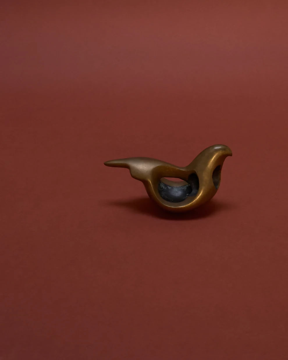 Bronze sculpture of a bird, likely a dove, with a rounded breast, placed against a red background,  available  to buy on the-salon.com. SALON curates the finest , unique, handmade pieces from the interior industry's best makers and brands. Shop luxury furniture, lighting, rugs, art, antiques and vintage pieces and accessories from SALON interior designed rooms.