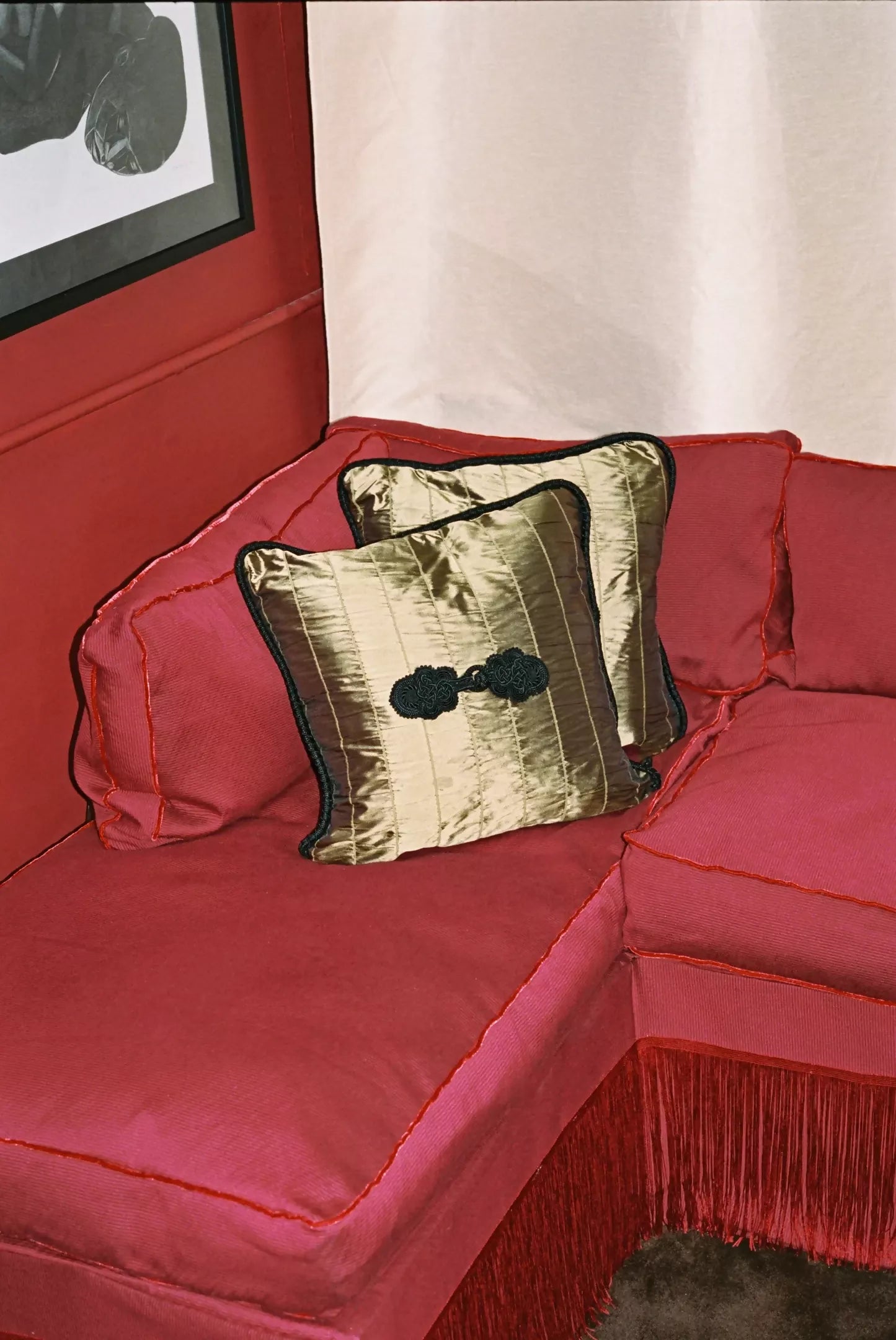 Close-up view of a red fabric with a textured weave pattern suitable for upholstery, shown on the sofa, available  to buy on the-salon.com. SALON curates the finest , unique, handmade pieces from the interior industry's best makers and brands. Shop luxury furniture, lighting, rugs, art, antiques and vintage pieces and accessories from SALON interior designed rooms.
