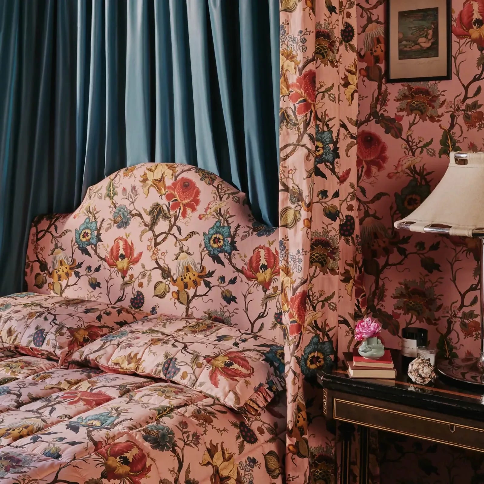 Floral-patterned sofa in a room with floral wallpaper and a lamp,  available  to buy on the-salon.com. SALON curates the finest , unique, handmade pieces from the interior industry's best makers and brands. Shop luxury furniture, lighting, rugs, art, antiques and vintage pieces and accessories from SALON interior designed rooms.