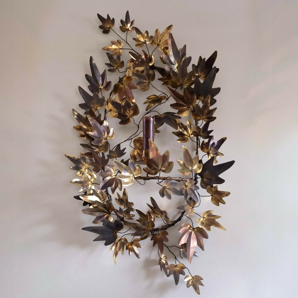 A brass candle wall sconce with patina finish designed by Jess Wheeler, featuring leaf shapes ,   available  to buy on the-salon.com. SALON curates the finest , unique, handmade pieces from the interior industry's best makers and brands. Shop luxury furniture, lighting, rugs, art, antiques and vintage pieces and accessories from SALON interior designed rooms.