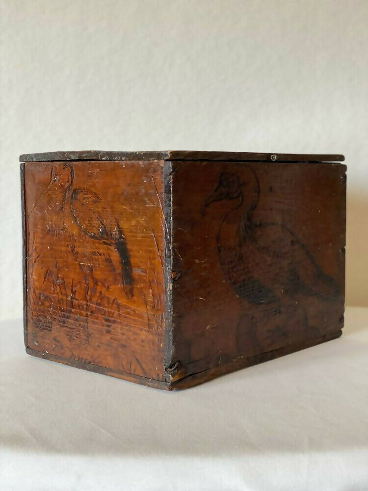 An 1800s wooden box with a carved bird, identified as a 'Pelican', on its surface, available  to buy on the-salon.com. SALON curates the finest , unique, handmade pieces from the interior industry's best makers and brands. Shop luxury furniture, lighting, rugs, art, antiques and vintage pieces and accessories from SALON interior designed rooms.