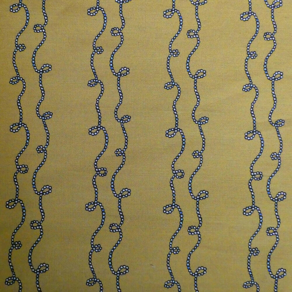 A swatch of fabric featuring a yellow background with a blue geometric pattern consisting of twisted shapes,  available  to buy on the-salon.com. SALON curates the finest , unique, handmade pieces from the interior industry's best makers and brands. Shop luxury furniture, lighting, rugs, art, antiques and vintage pieces and accessories from SALON interior designed rooms.